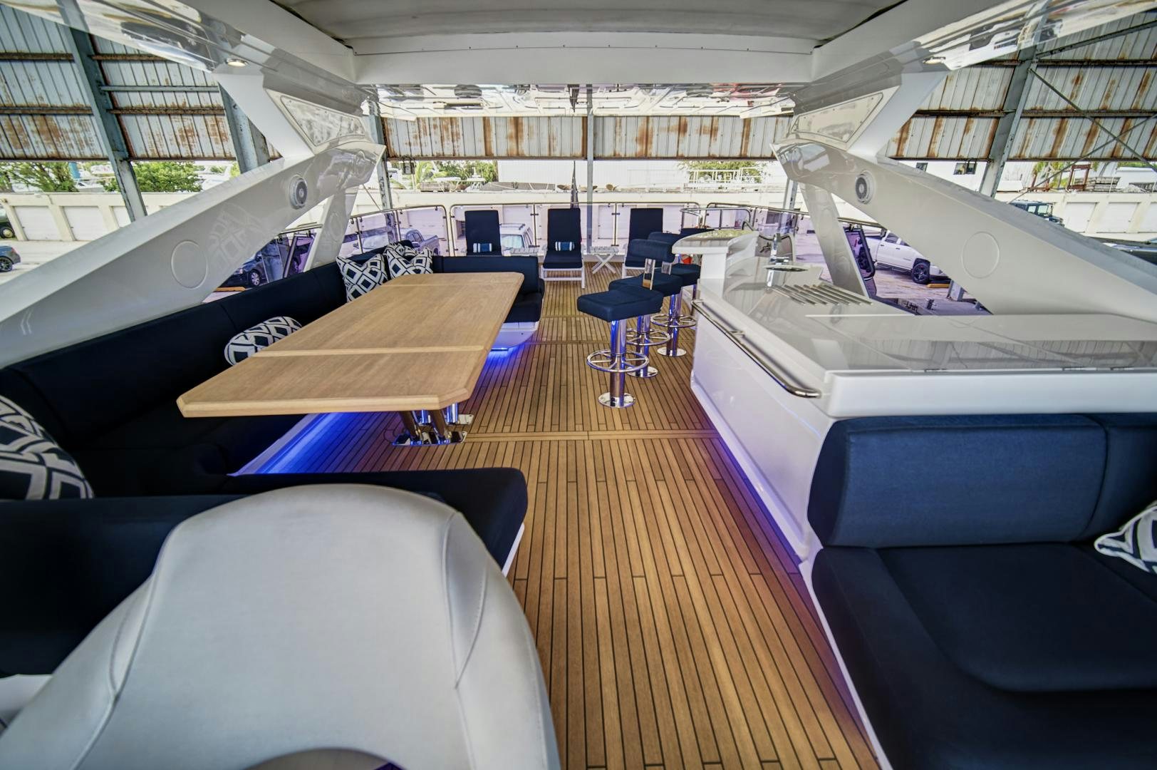 inside of a building with a wooden deck and chairs aboard 'S NOON SOMEWHERE Yacht for Sale