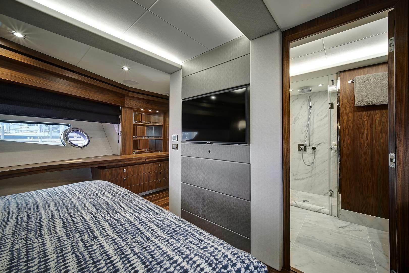 a bedroom with a bed and a television aboard 'S NOON SOMEWHERE Yacht for Sale