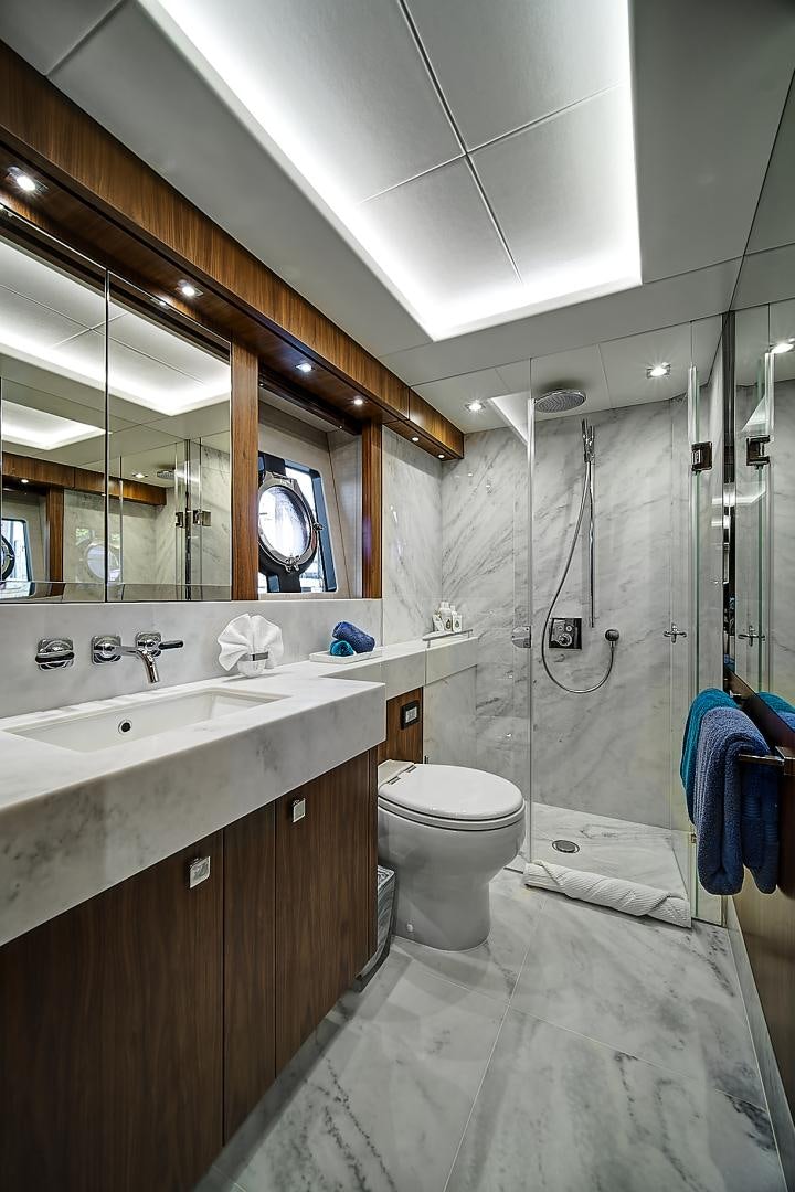 a bathroom with a sink toilet and a mirror aboard 'S NOON SOMEWHERE Yacht for Sale