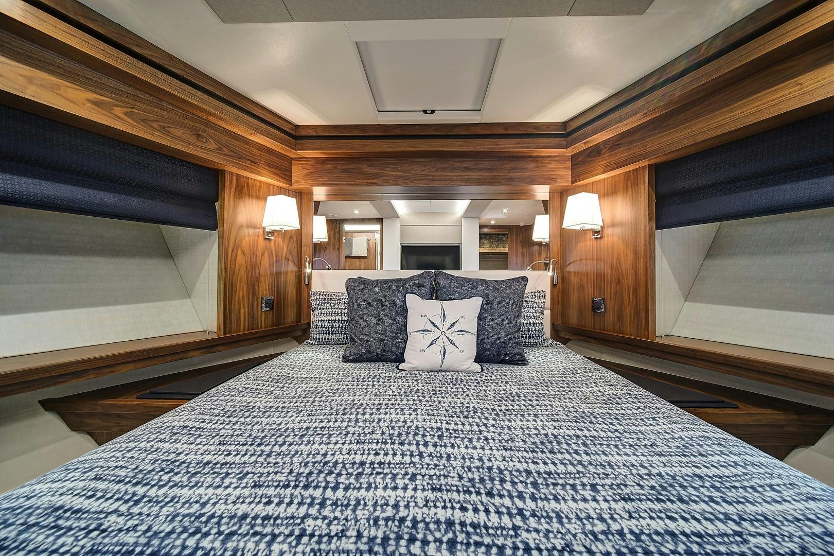 a bed with a blue and white bed spread aboard 'S NOON SOMEWHERE Yacht for Sale