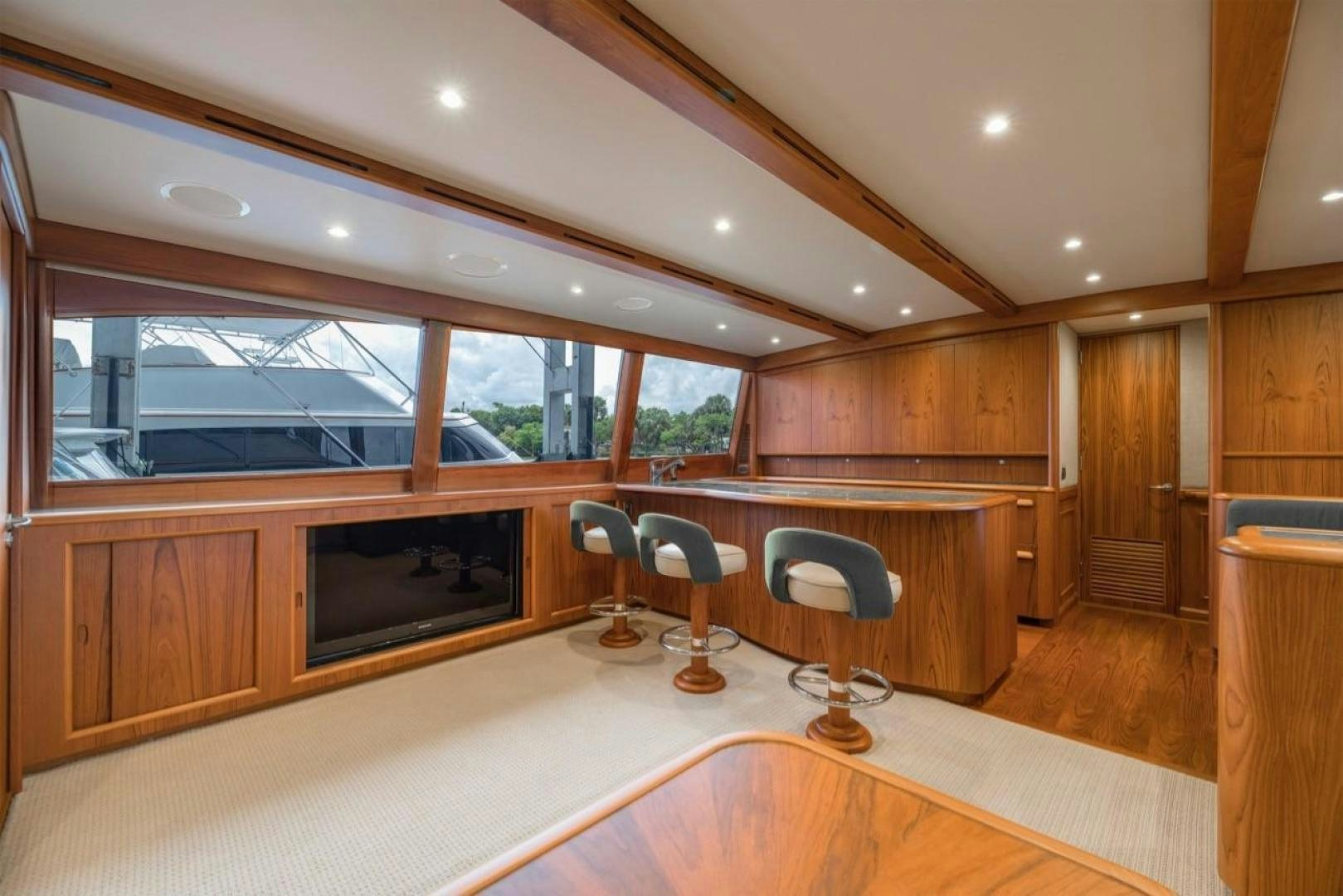 a room with a tv and a chair aboard DESTINY Yacht for Sale