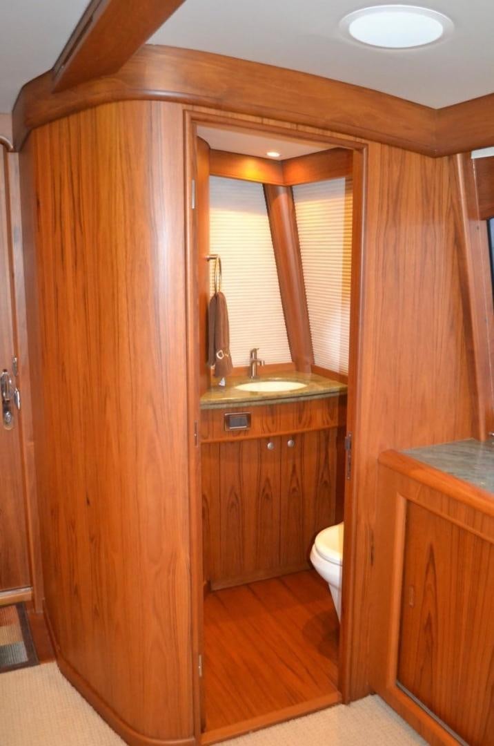 a bathroom with wooden cabinets aboard DESTINY Yacht for Sale