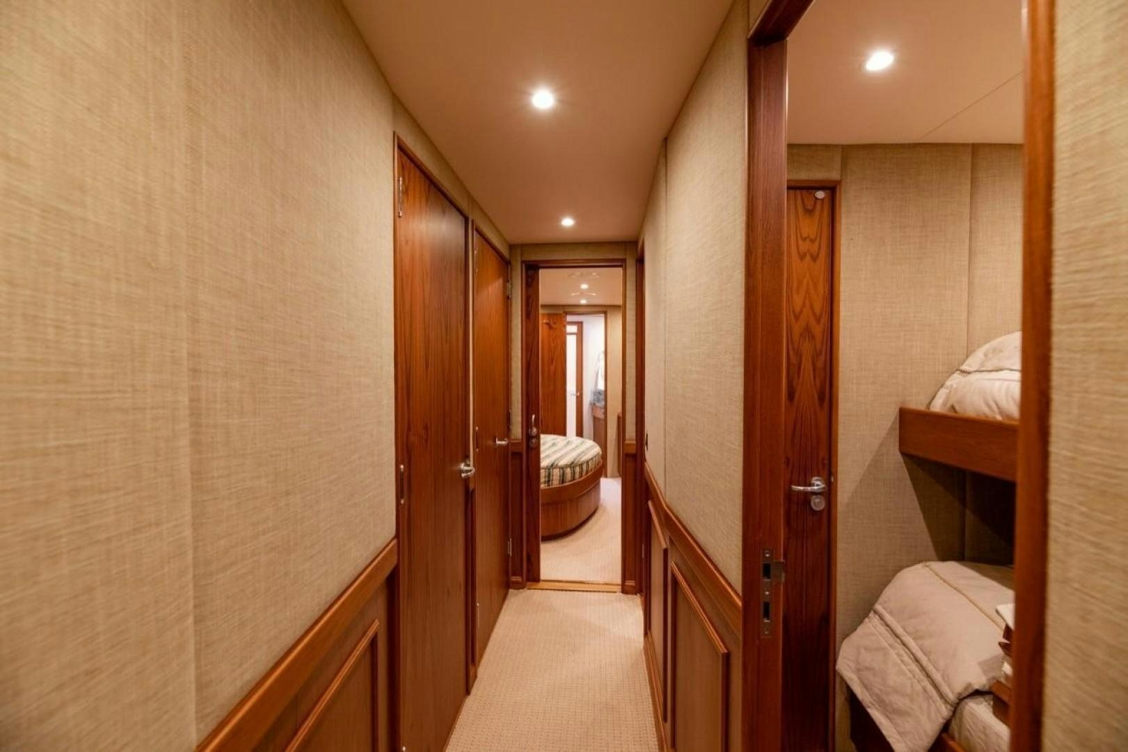 a room with a bed and a door aboard DESTINY Yacht for Sale
