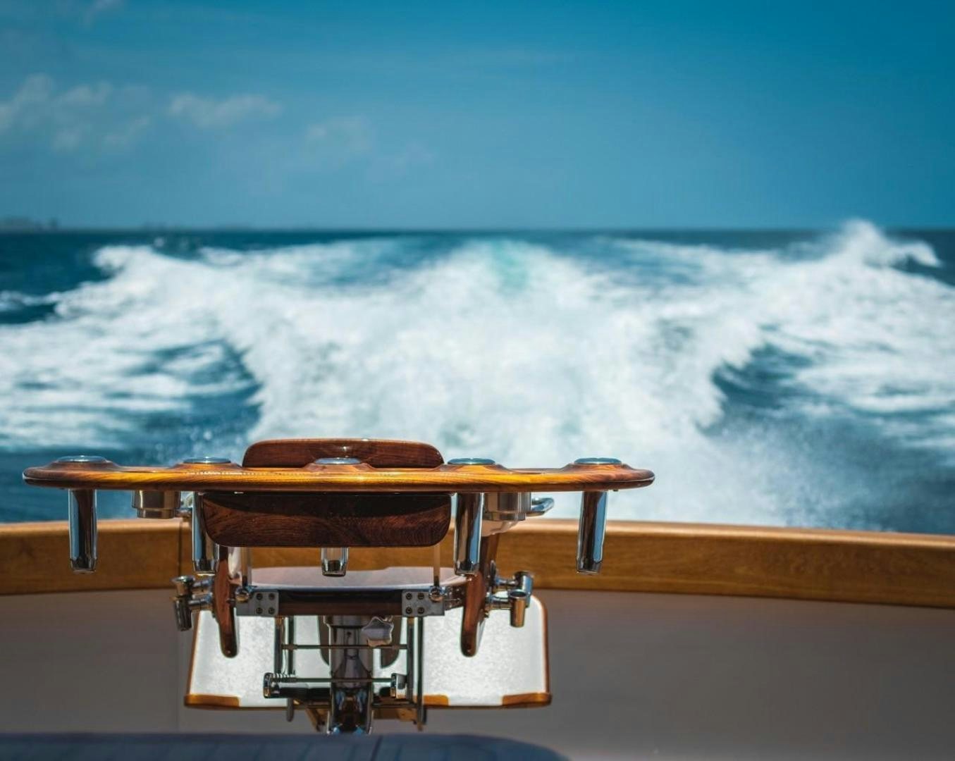a wooden boat on a railing overlooking a large body of water aboard DESTINY Yacht for Sale