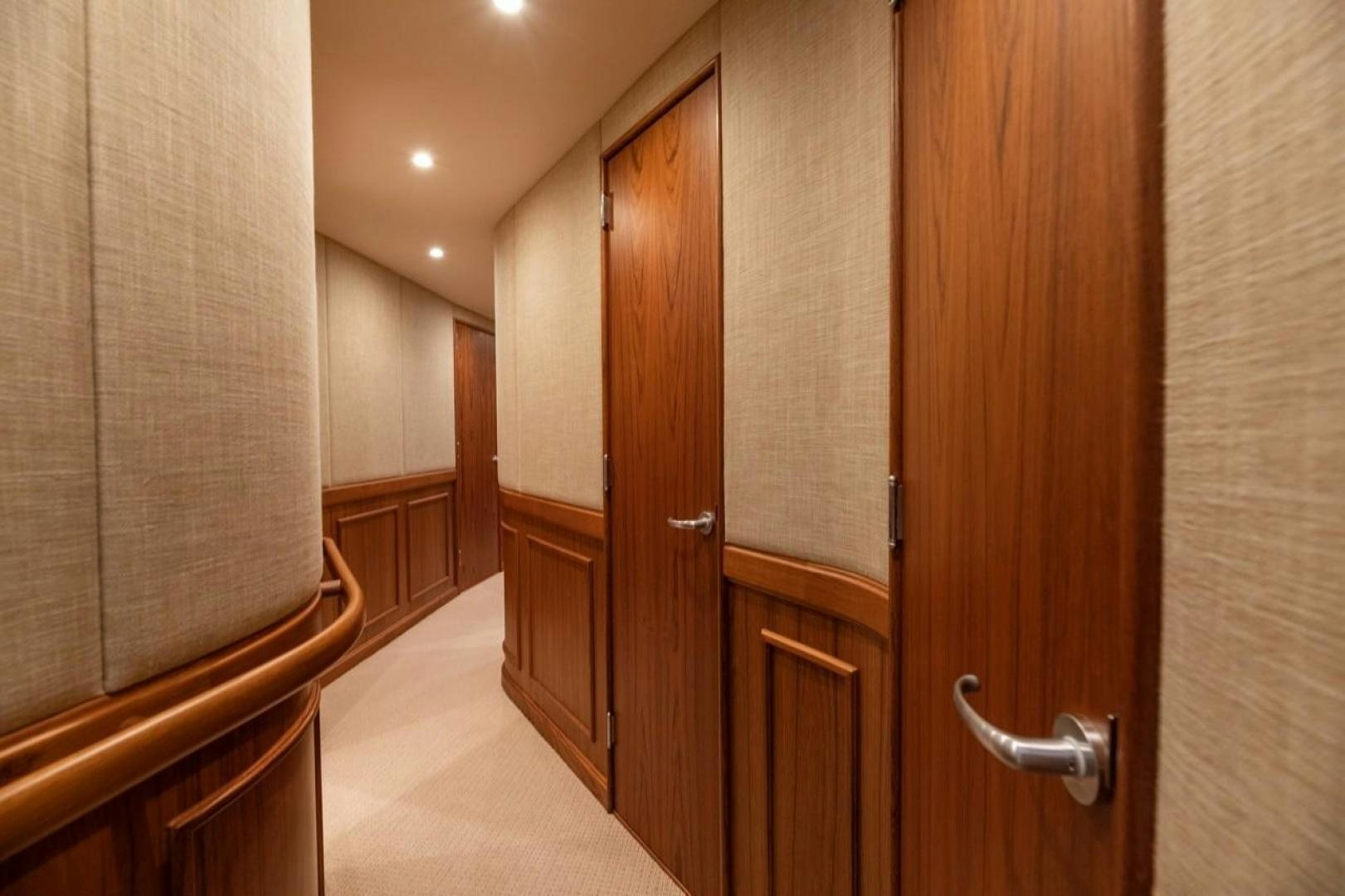 a hallway with wooden doors aboard DESTINY Yacht for Sale