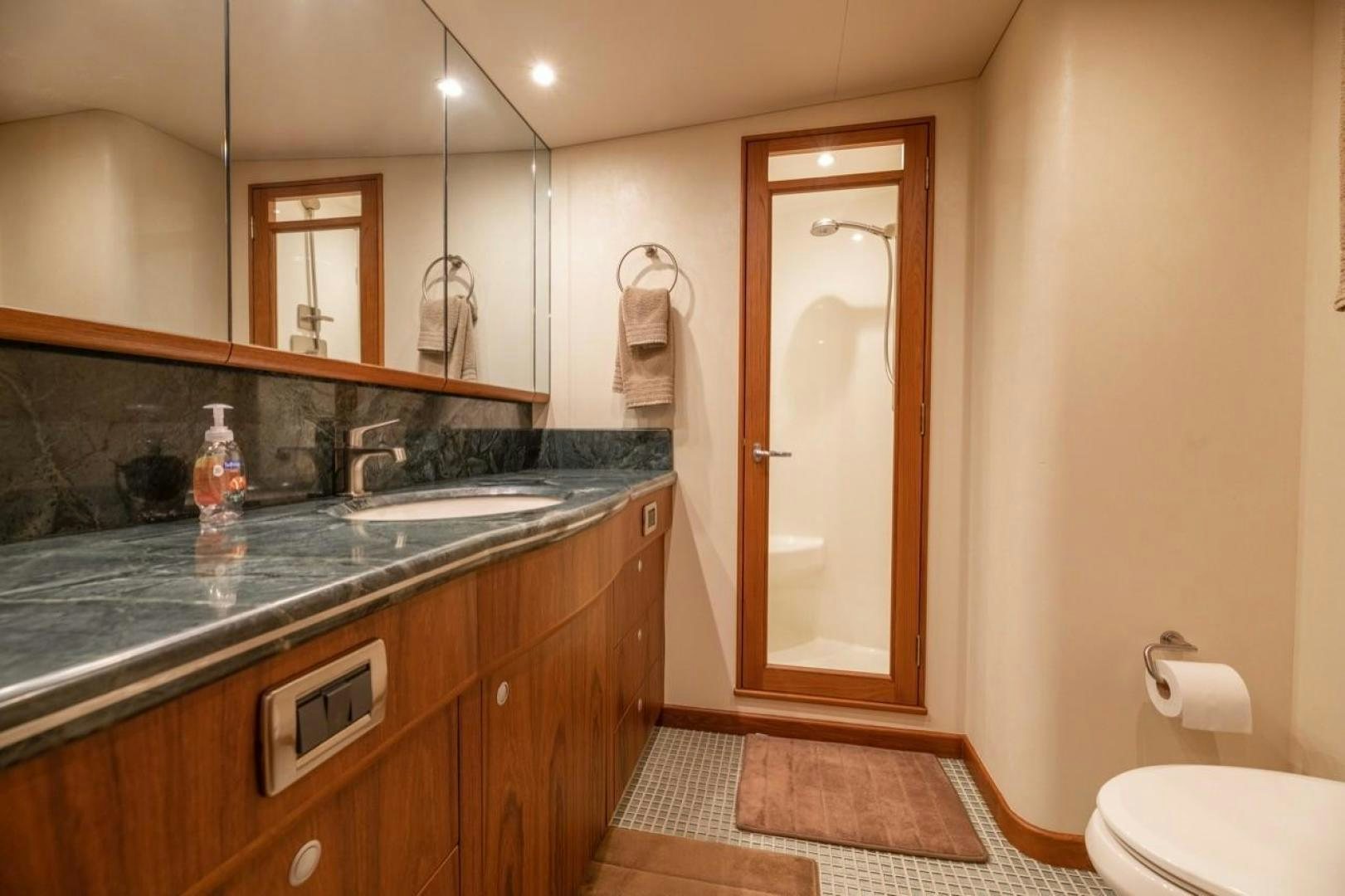 a bathroom with a countertop sink and a mirror aboard DESTINY Yacht for Sale