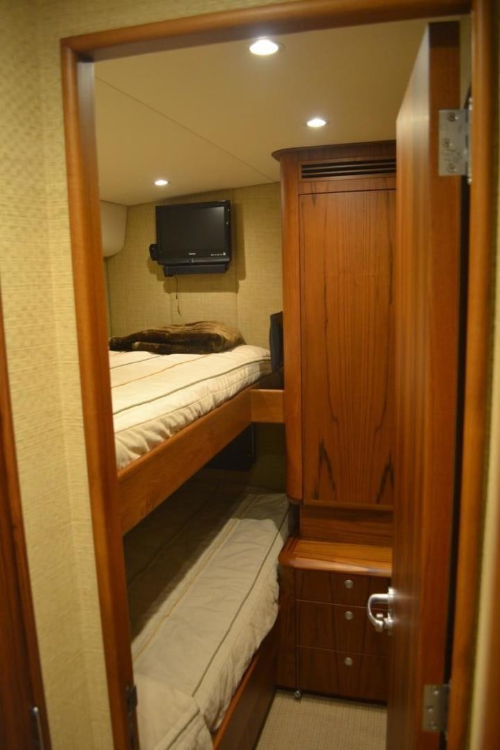 a room with a tv and a closet aboard DESTINY Yacht for Sale