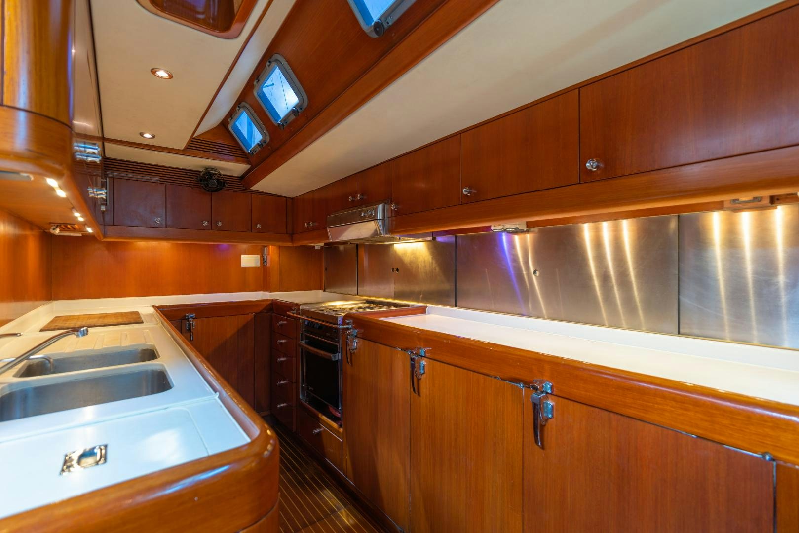 a kitchen with wooden cabinets aboard ASPIRATION Yacht for Sale