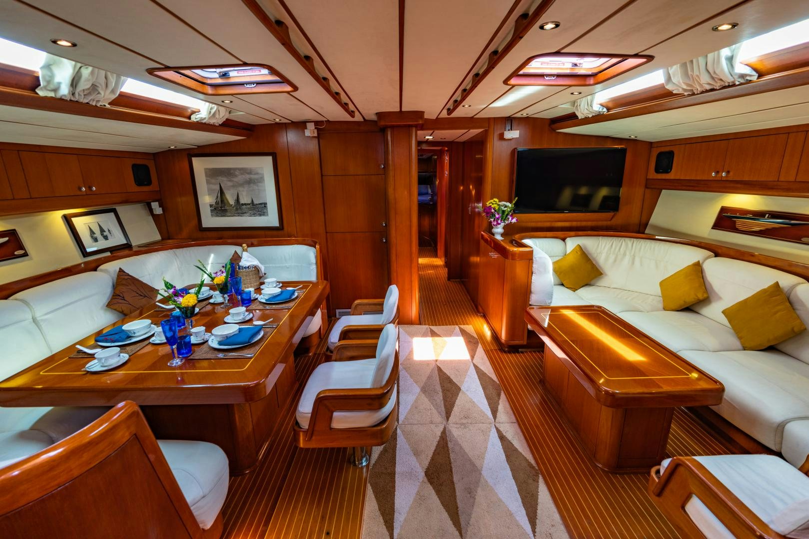 a room with a table chairs and a tv aboard ASPIRATION Yacht for Sale