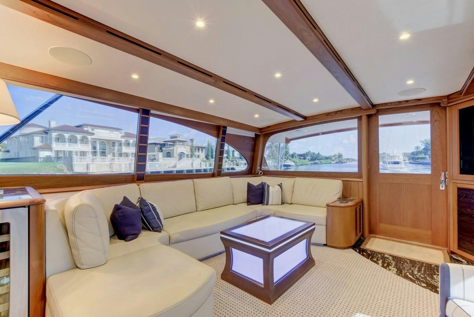 a living room with a couch and a table aboard III AMIGOS Yacht for Sale