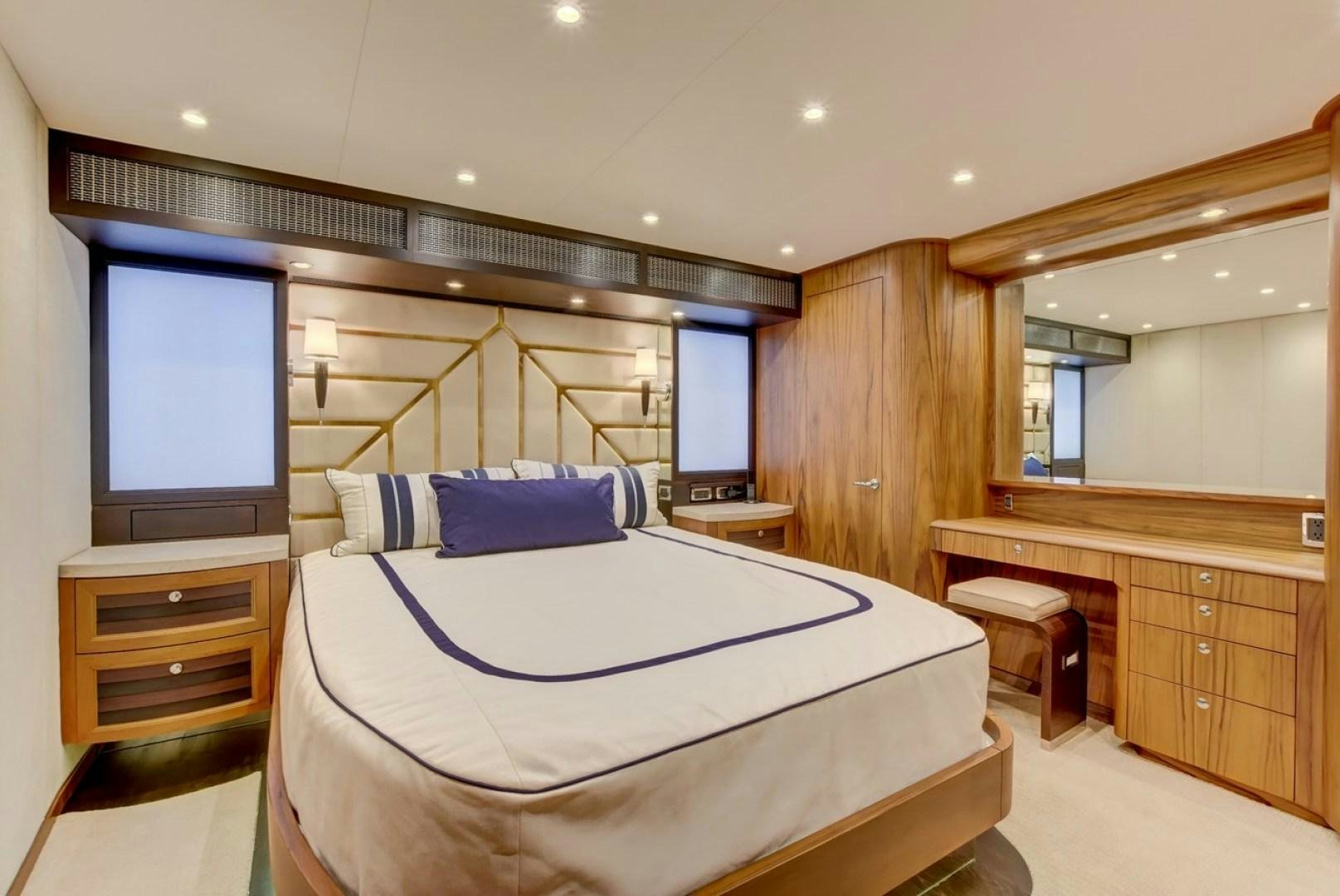 a bedroom with a large bed aboard III AMIGOS Yacht for Sale