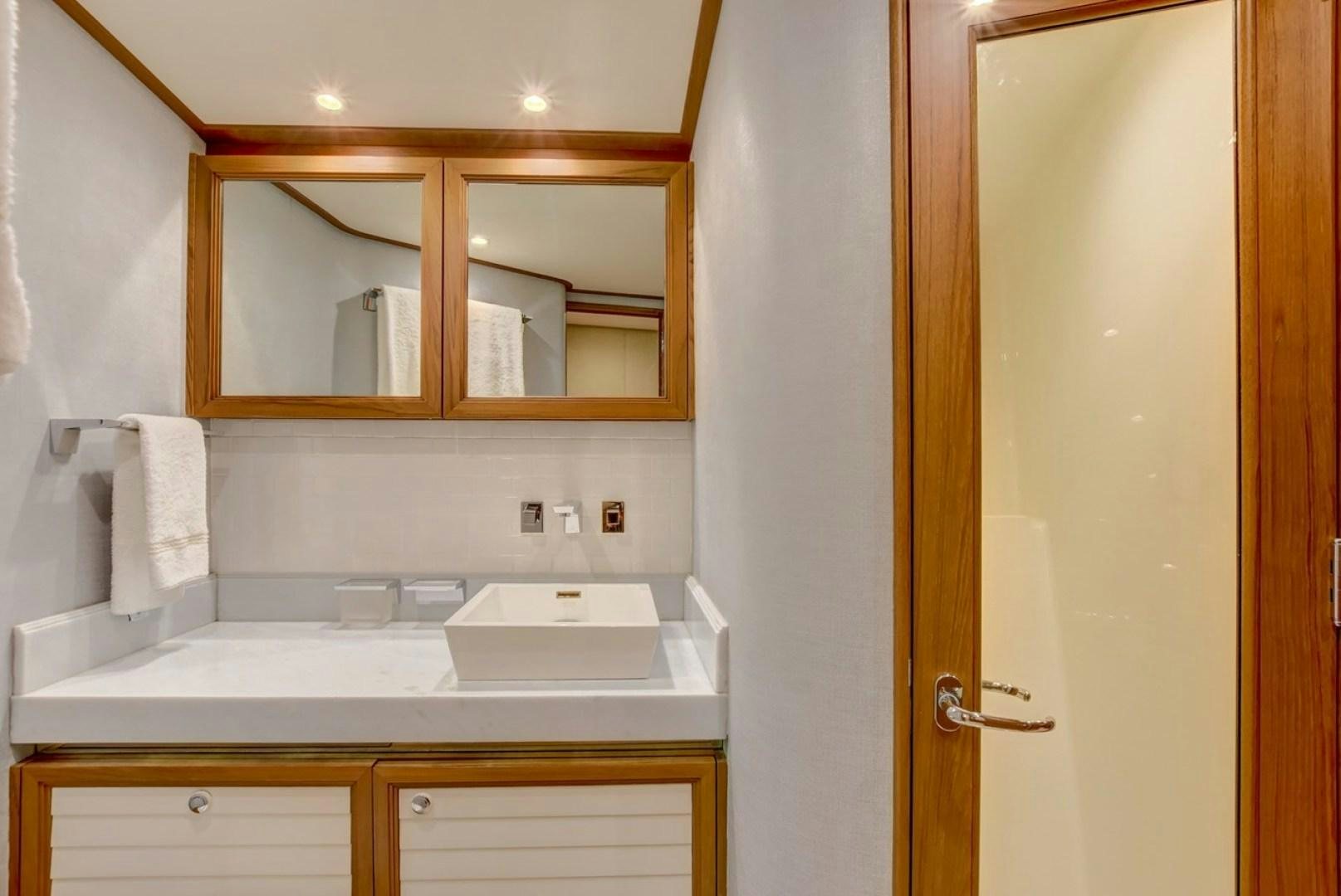 a bathroom with a sink and cabinets aboard III AMIGOS Yacht for Sale