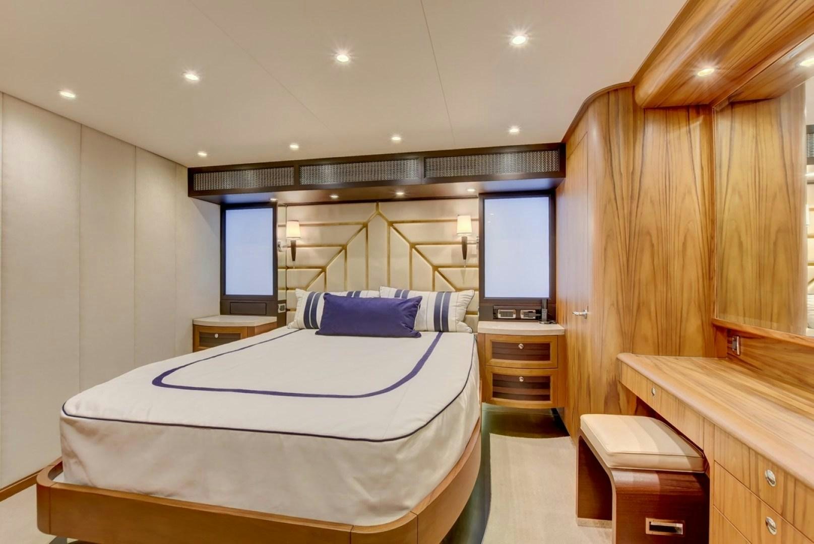 a room with a bed and a desk aboard III AMIGOS Yacht for Sale