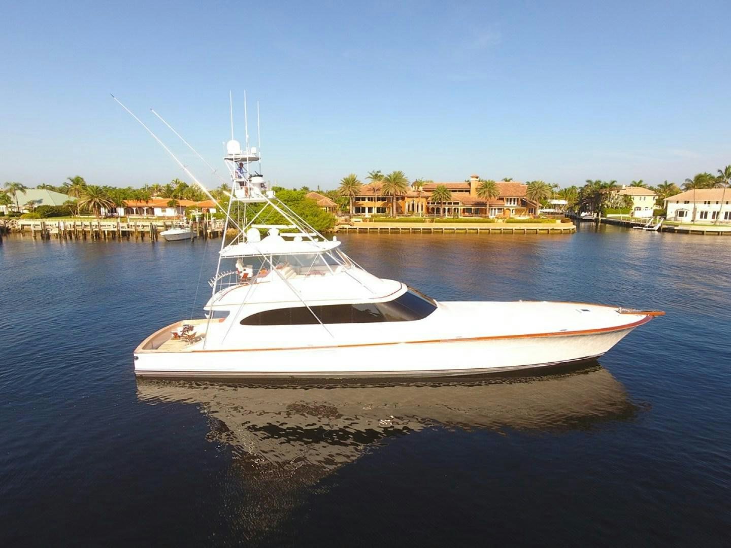 a white boat on the water aboard III AMIGOS Yacht for Sale