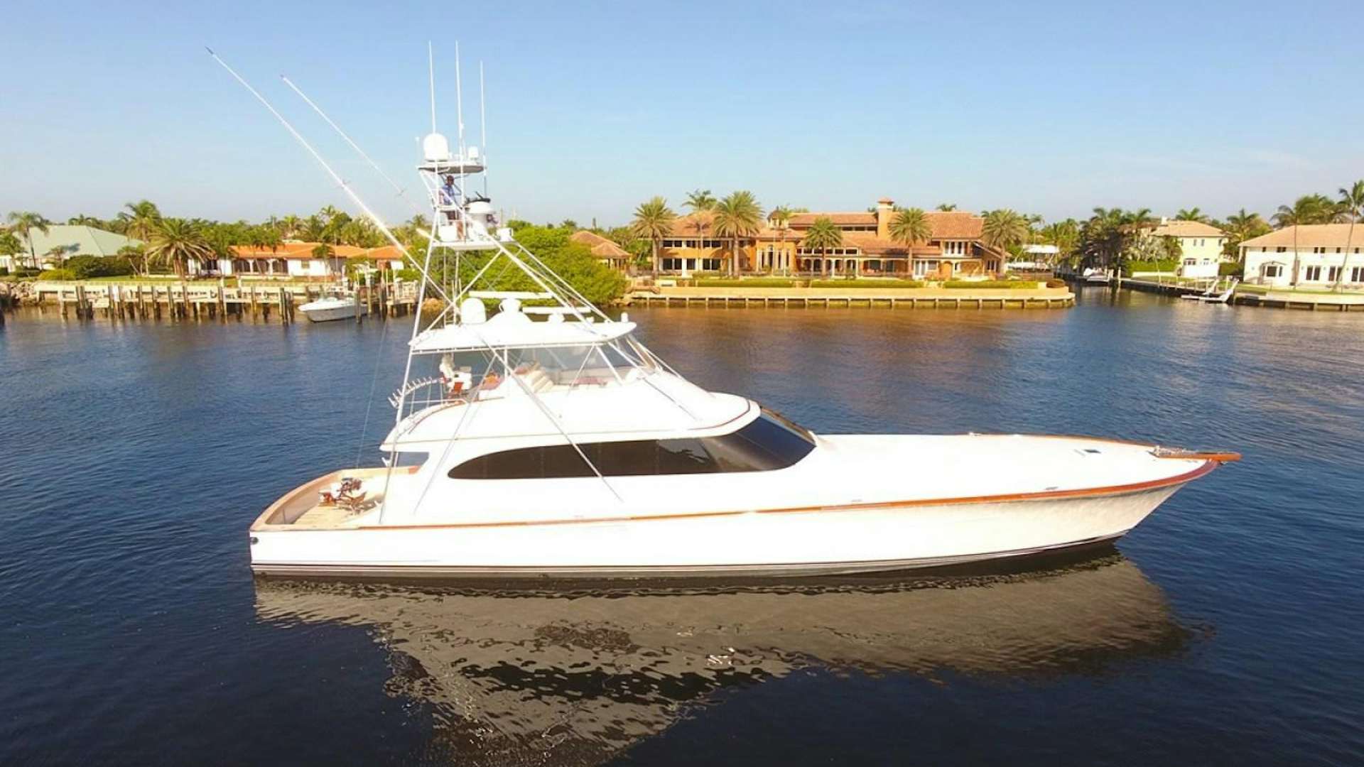 a white boat on the water aboard III AMIGOS Yacht for Sale