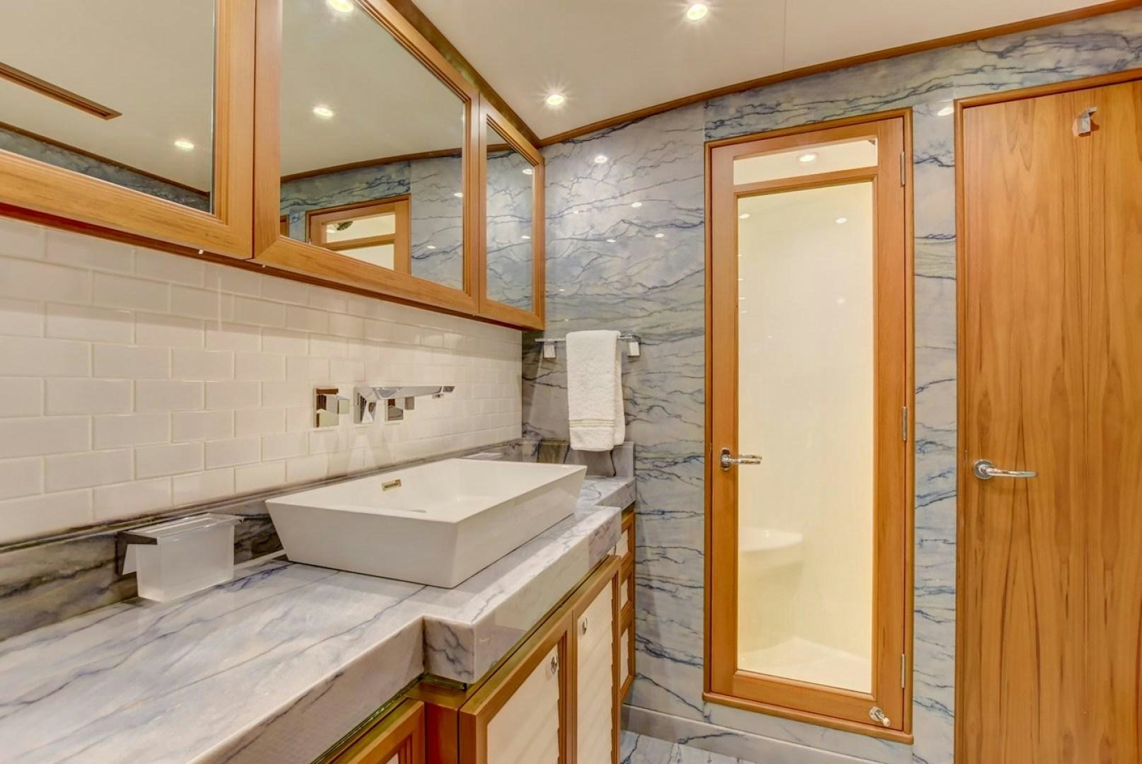 a bathroom with a sink and a shower aboard III AMIGOS Yacht for Sale