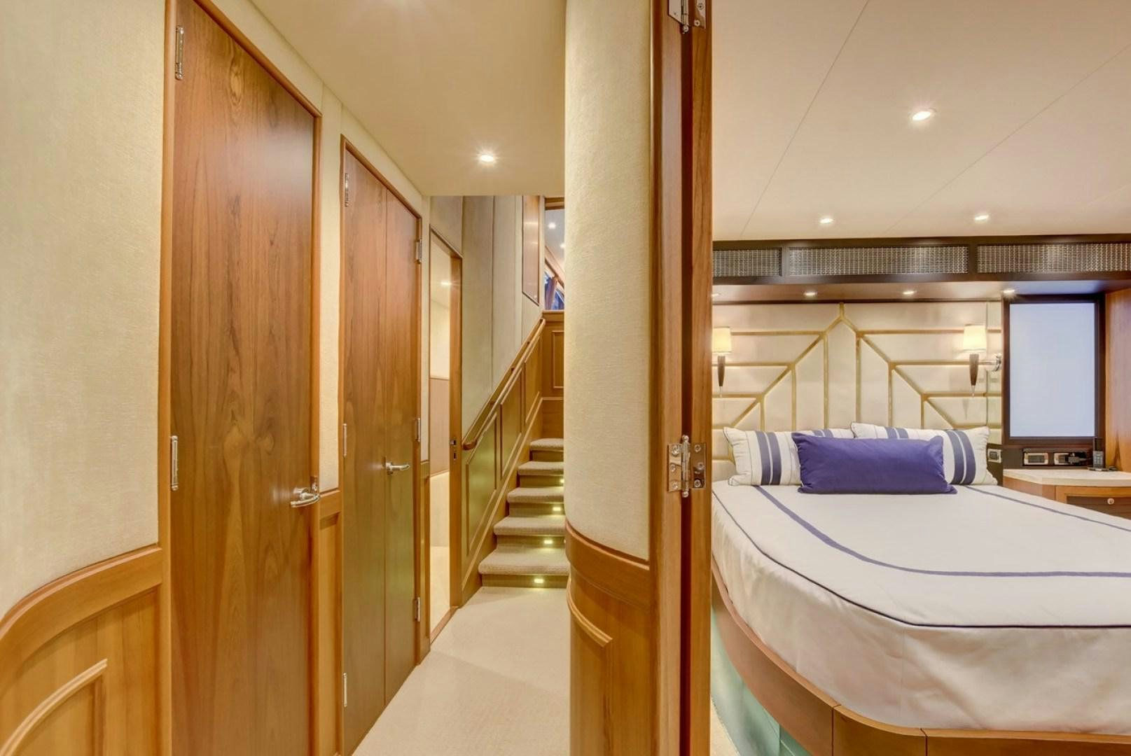 a room with a bed and a door aboard III AMIGOS Yacht for Sale