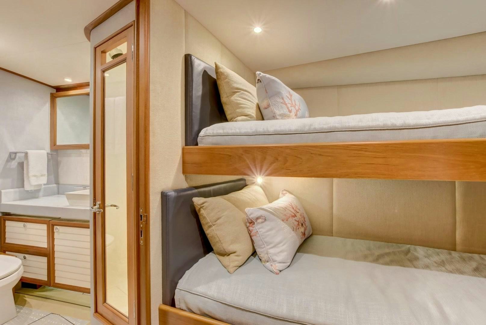 a bed with a white bed spread aboard III AMIGOS Yacht for Sale