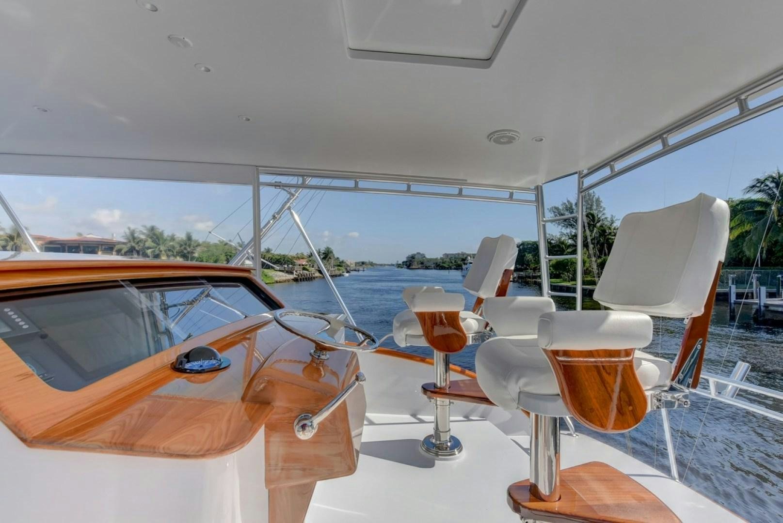 a boat with a glass of wine and a table with chairs aboard III AMIGOS Yacht for Sale