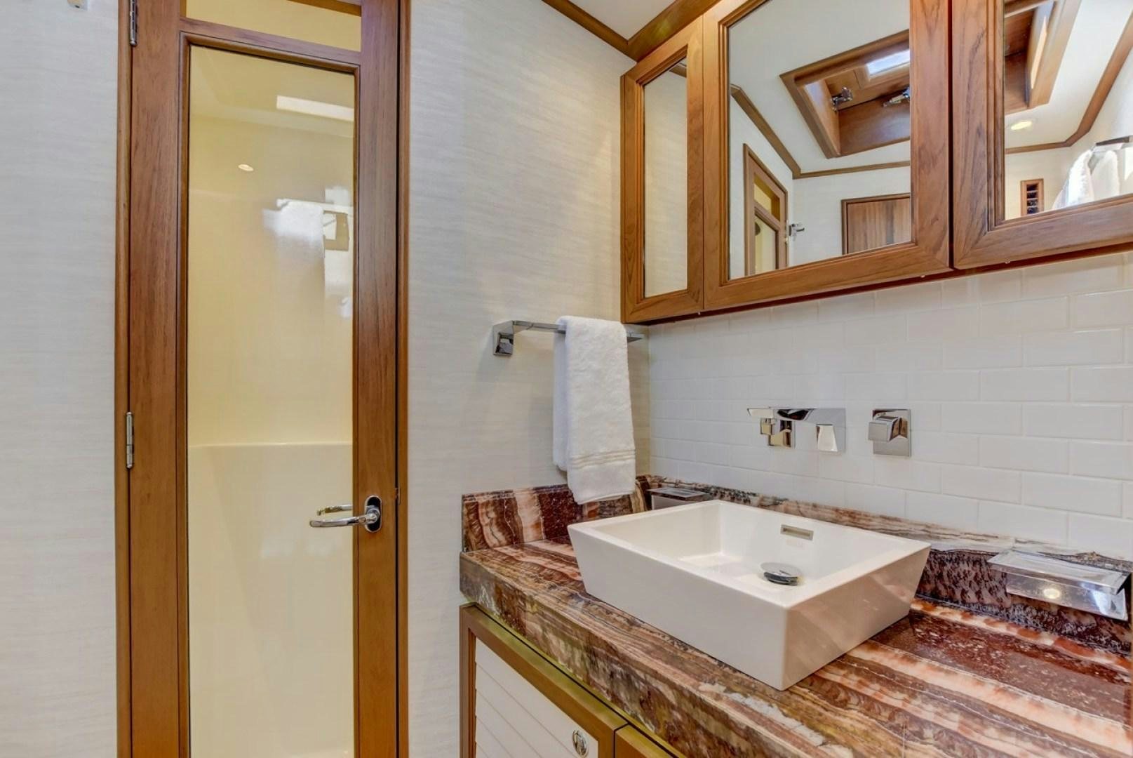 a bathroom with a sink and a mirror aboard III AMIGOS Yacht for Sale