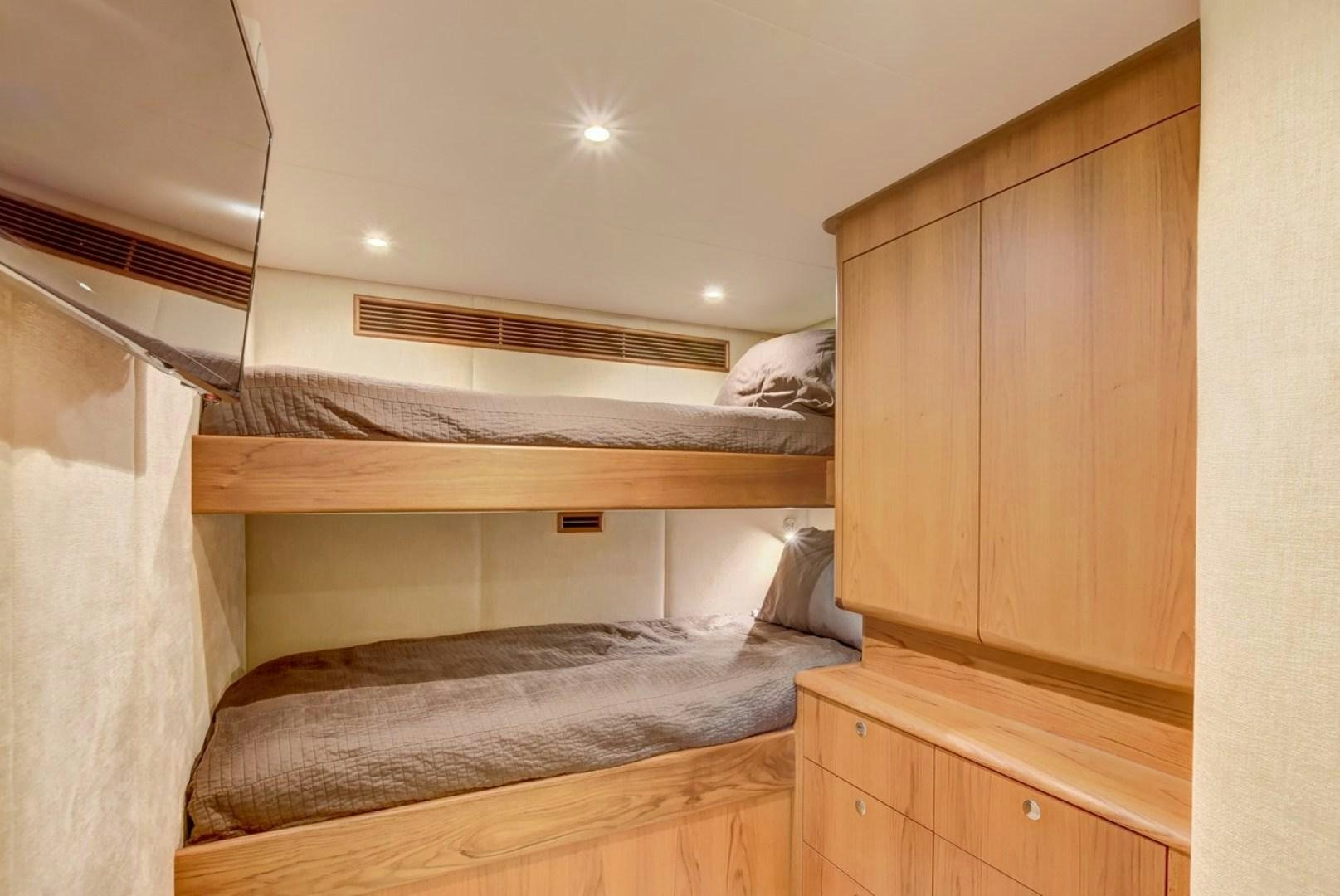 a room with a bed and a closet aboard III AMIGOS Yacht for Sale