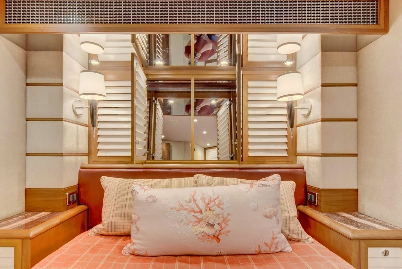 a bed with a mirror above it aboard III AMIGOS Yacht for Sale