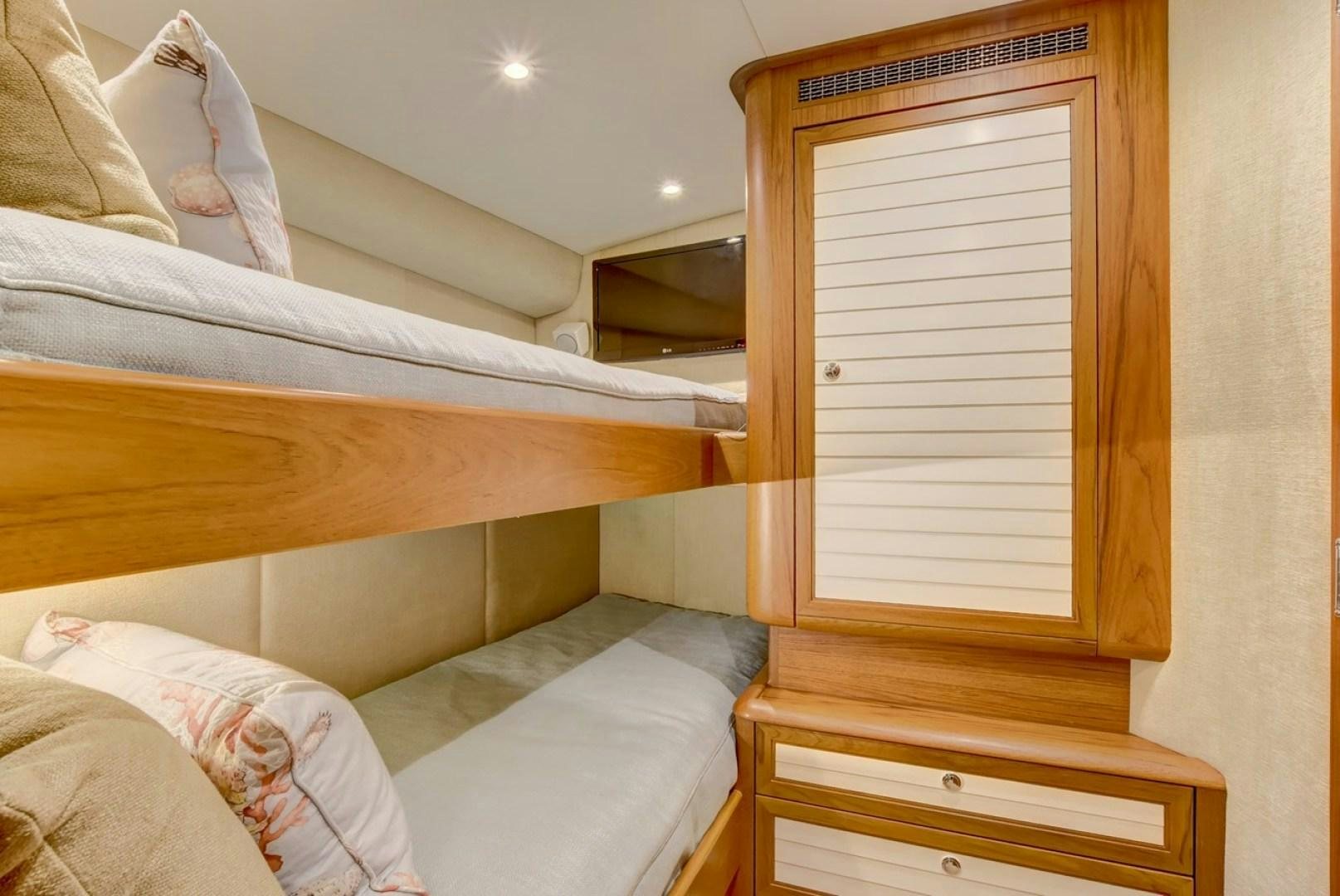 a room with a bed and a window aboard III AMIGOS Yacht for Sale