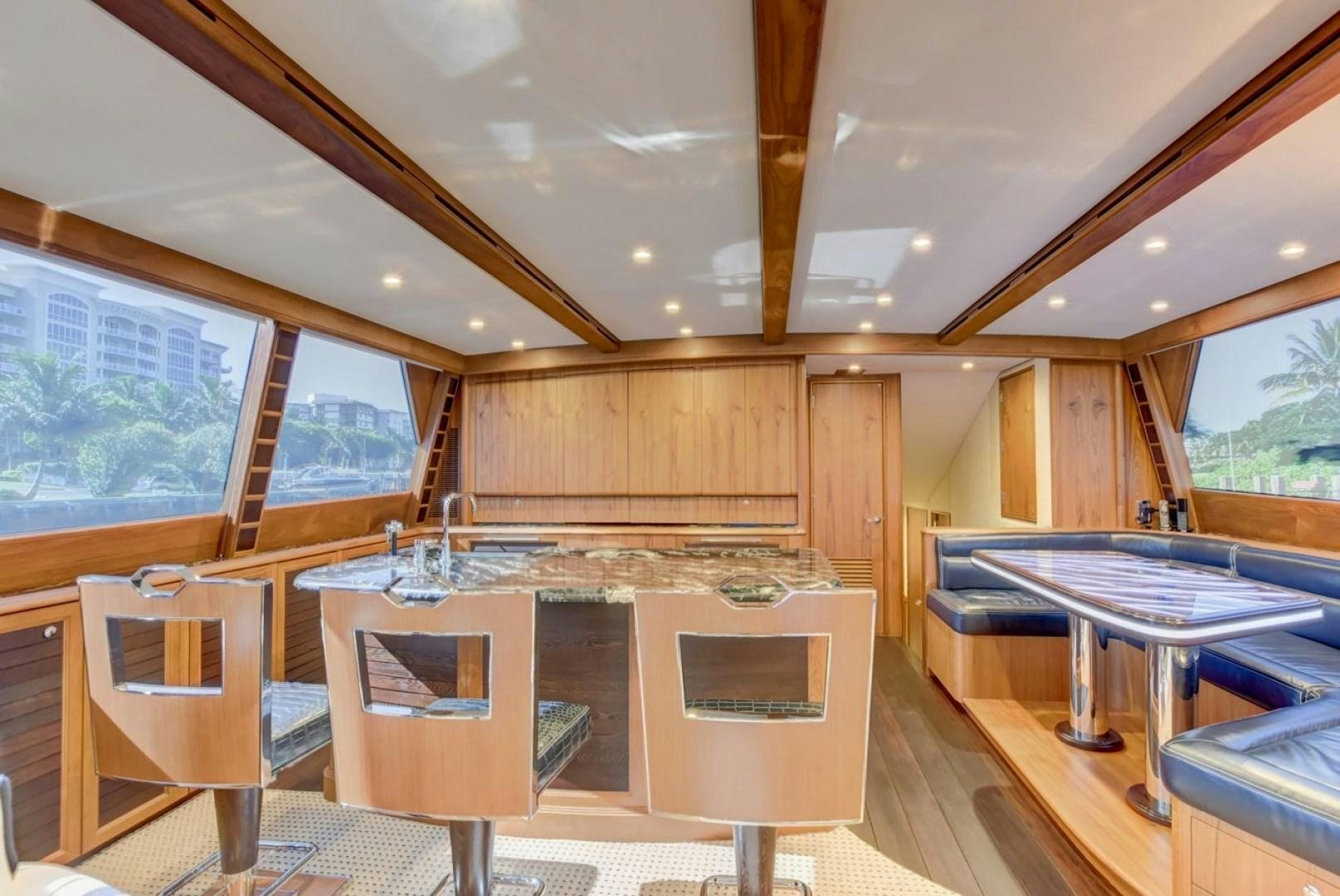 a room with a table and chairs aboard III AMIGOS Yacht for Sale