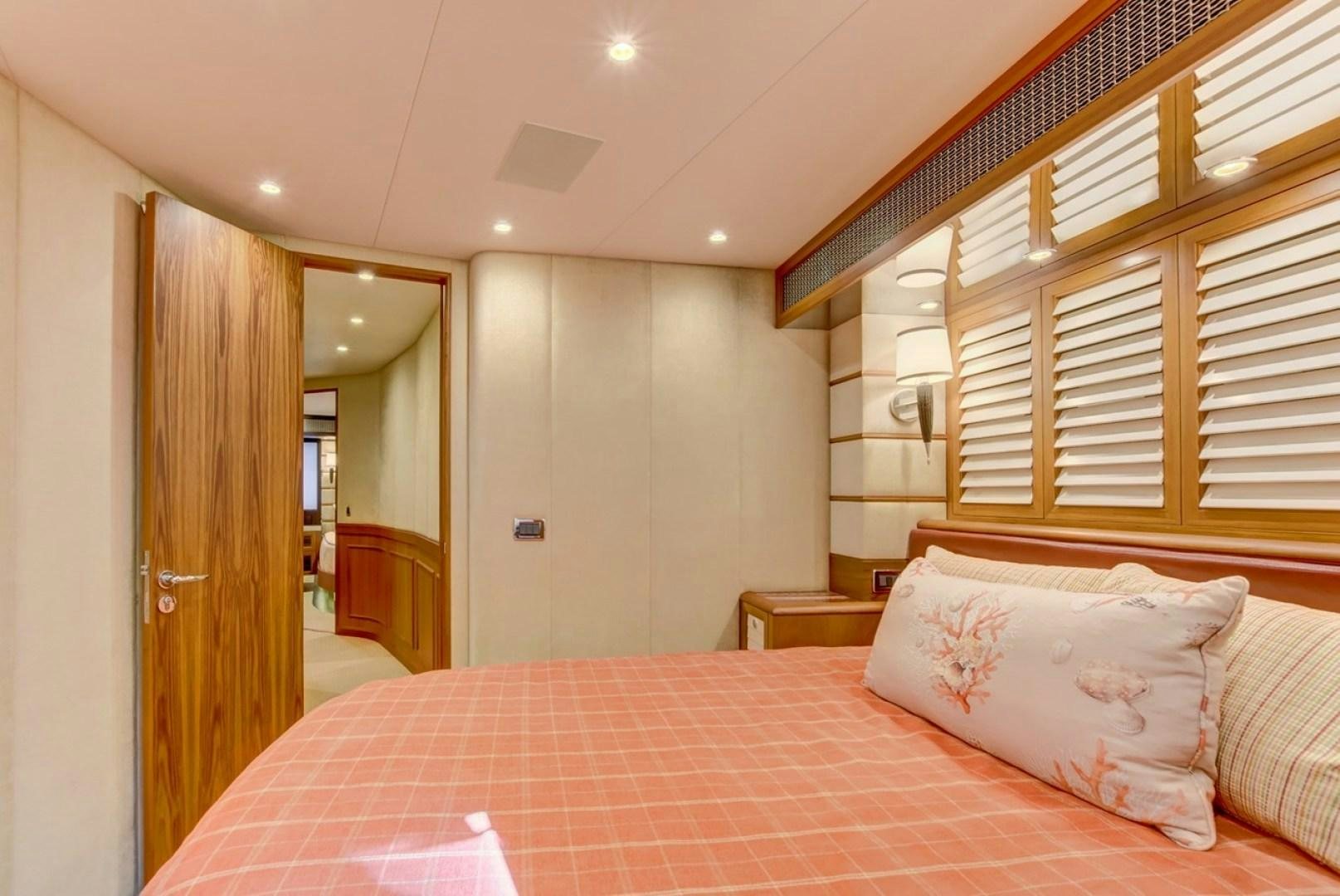 a bed with pink sheets aboard III AMIGOS Yacht for Sale