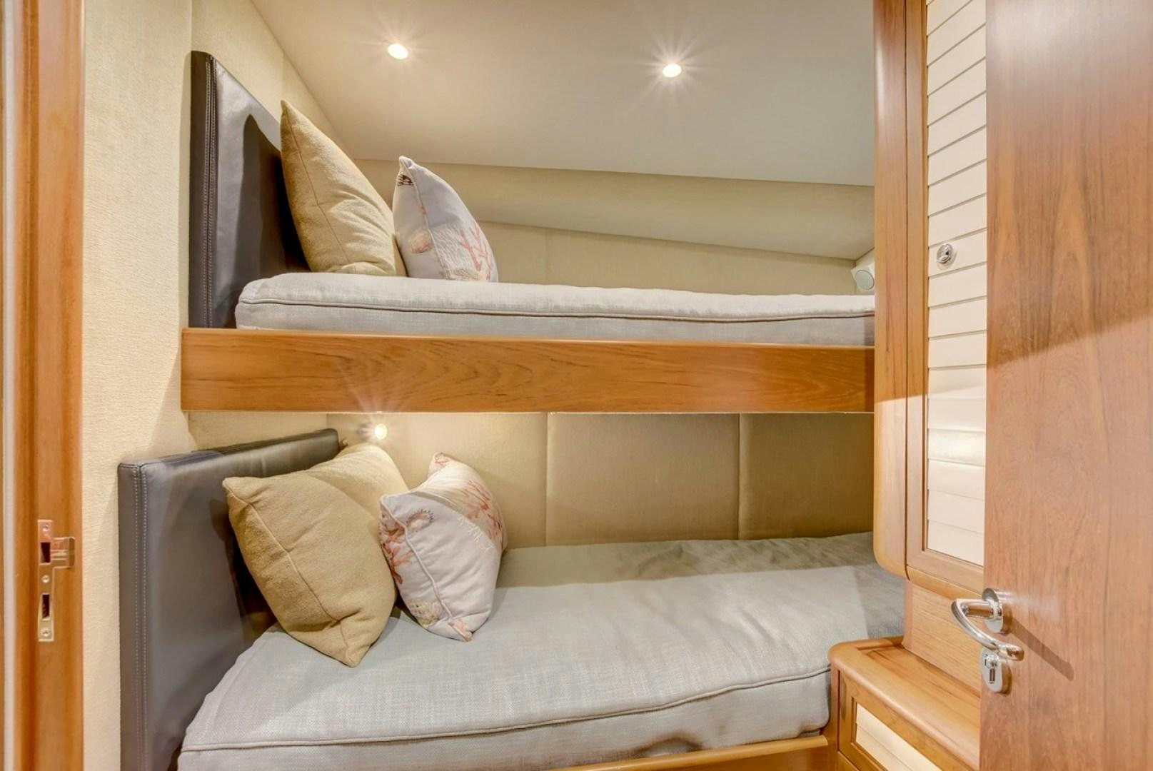 a bed with a pillow on it aboard III AMIGOS Yacht for Sale