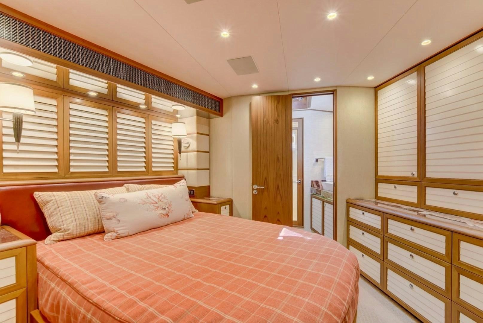 a bedroom with a bed and a window aboard III AMIGOS Yacht for Sale