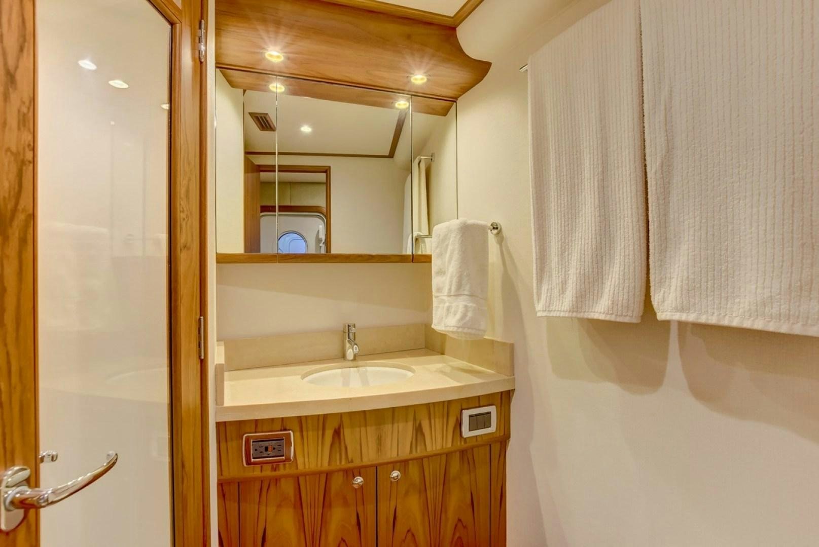 a bathroom with a sink and a mirror aboard III AMIGOS Yacht for Sale