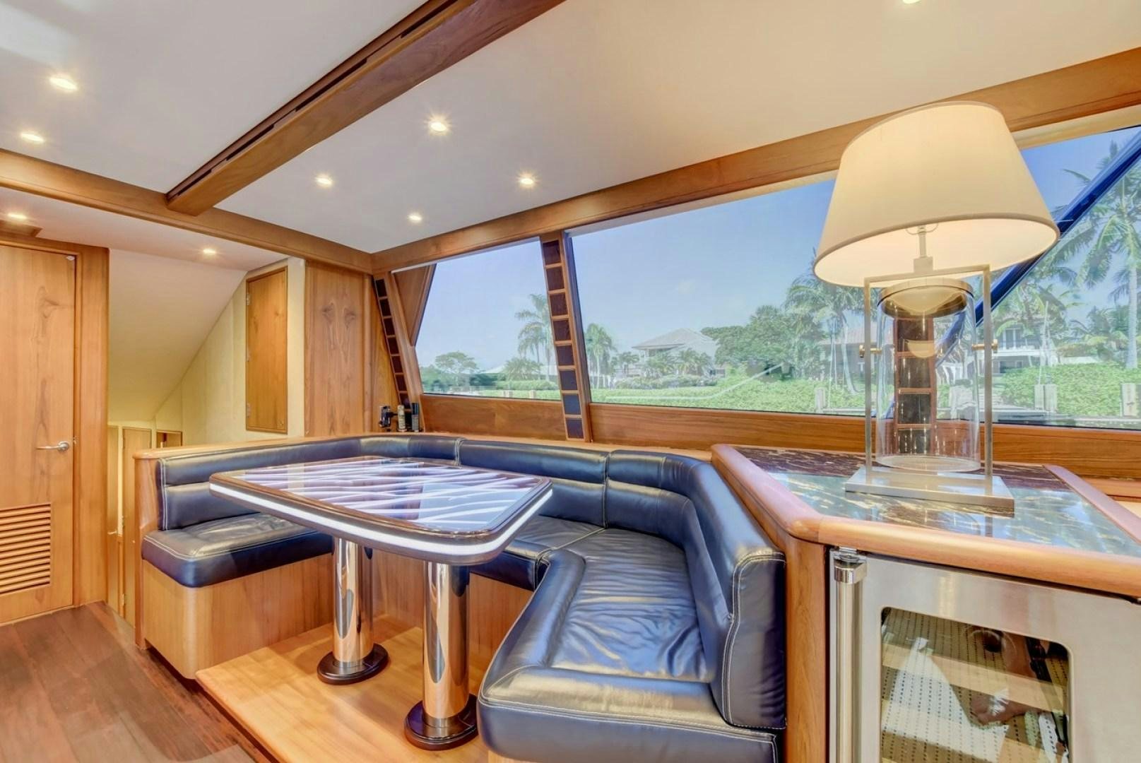 a room with a table and a lamp aboard III AMIGOS Yacht for Sale