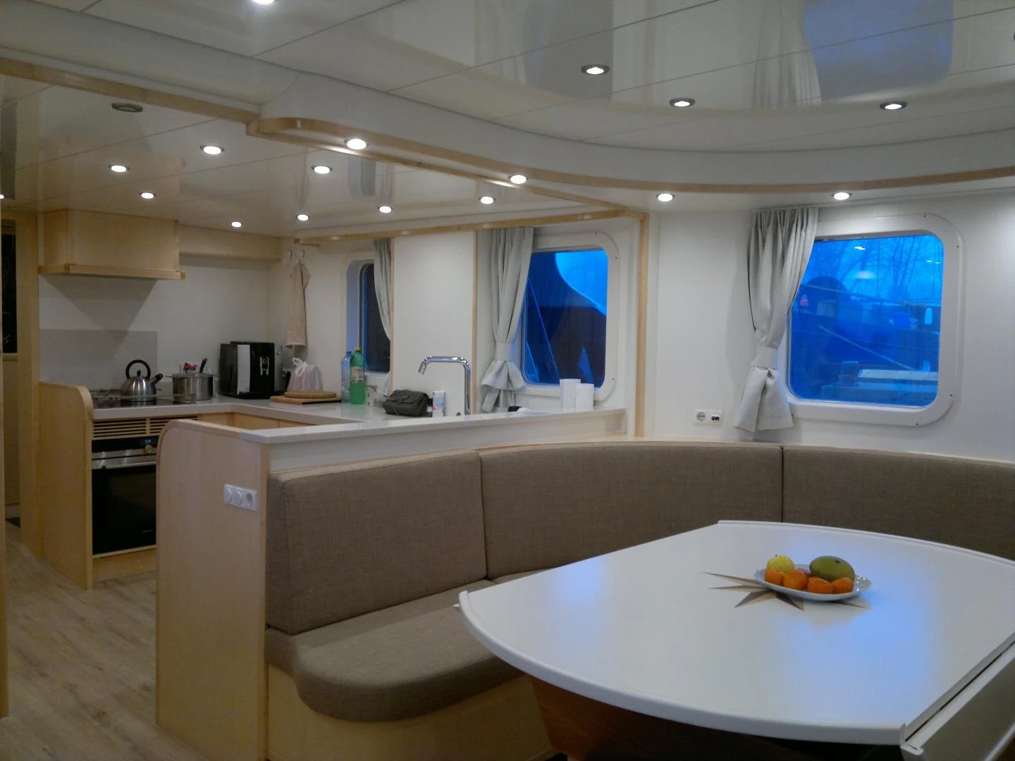 a kitchen with a table and a window aboard ELENA Yacht for Sale