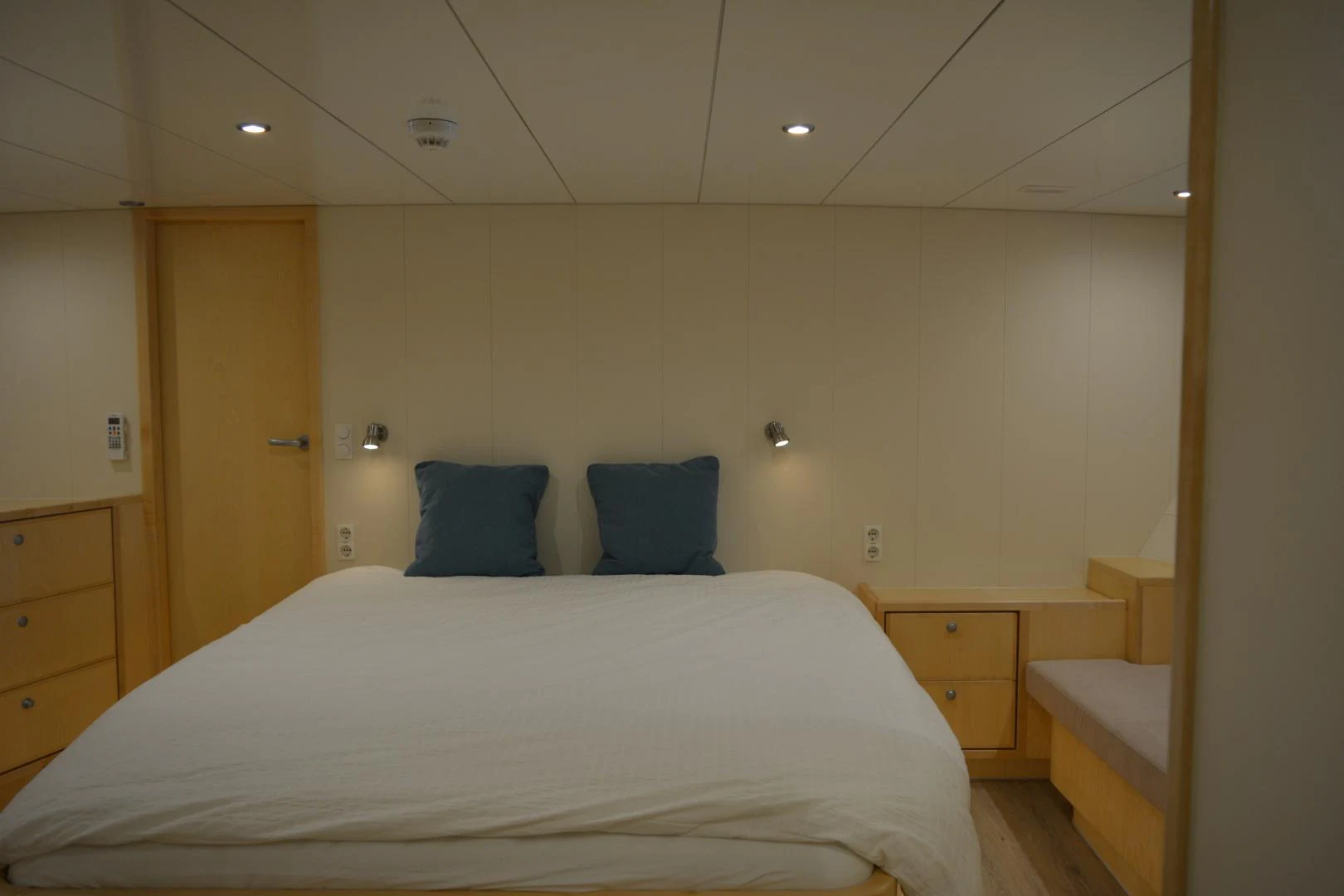 a bedroom with a bed and a desk aboard ELENA Yacht for Sale