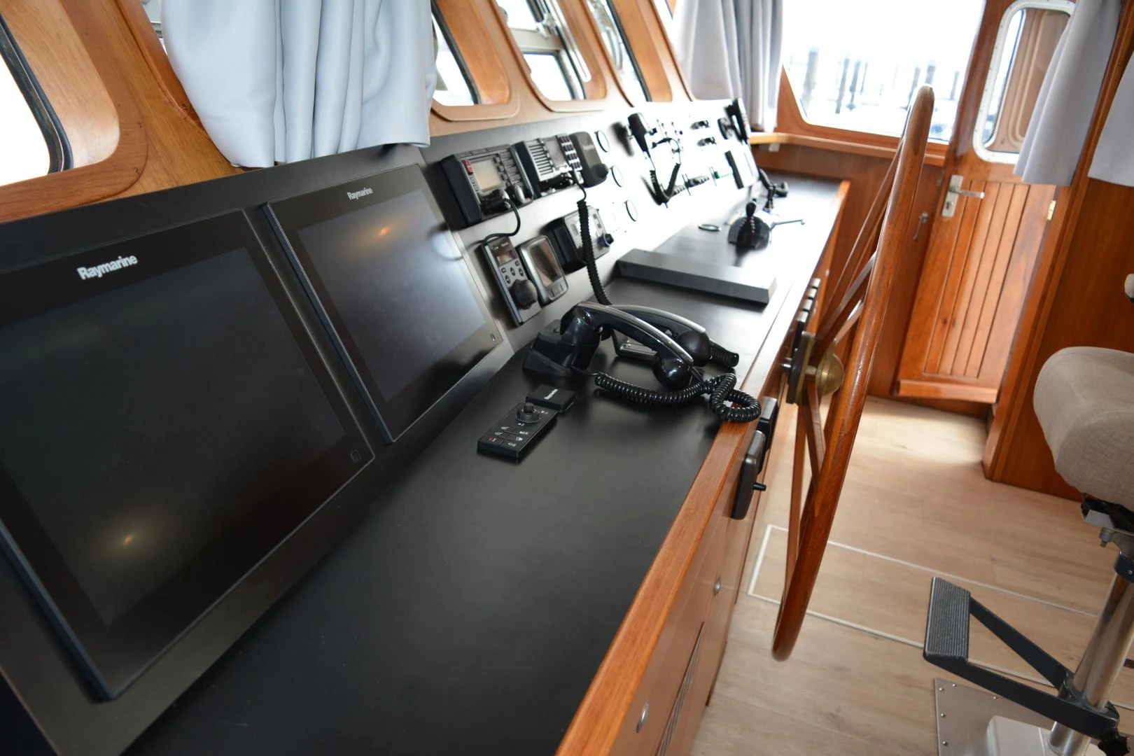 a black and white computer on a black desk aboard ELENA Yacht for Sale