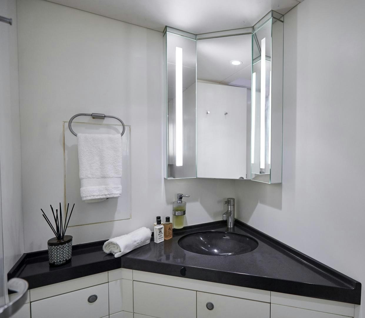 a bathroom with a sink and mirror aboard CAPRICHO II Yacht for Sale