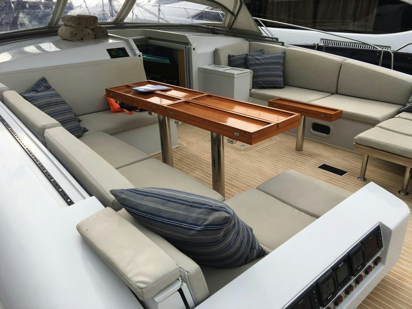 a car with a table and chairs aboard CAPRICHO II Yacht for Sale