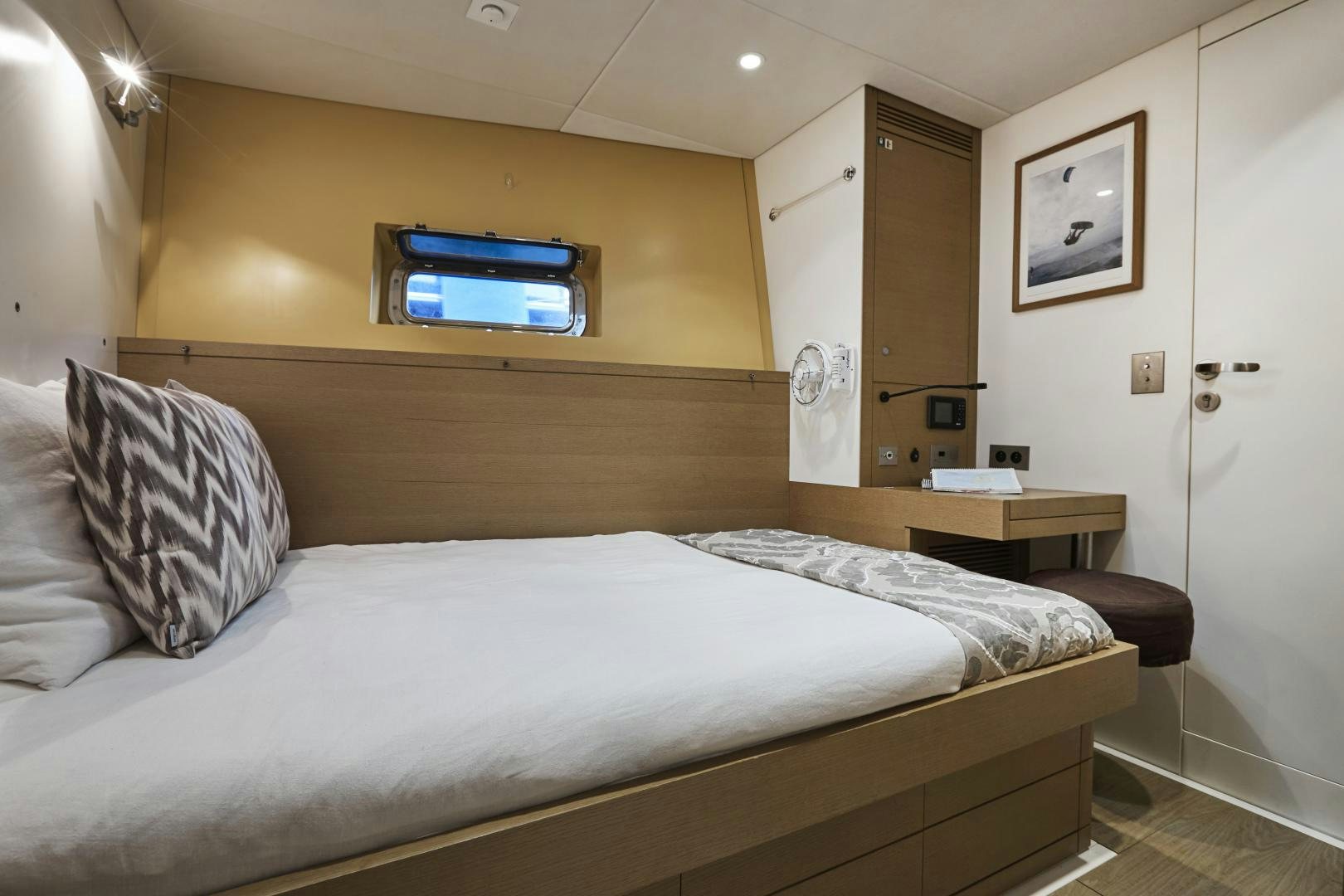 a bed with a television on the wall aboard CAPRICHO II Yacht for Sale
