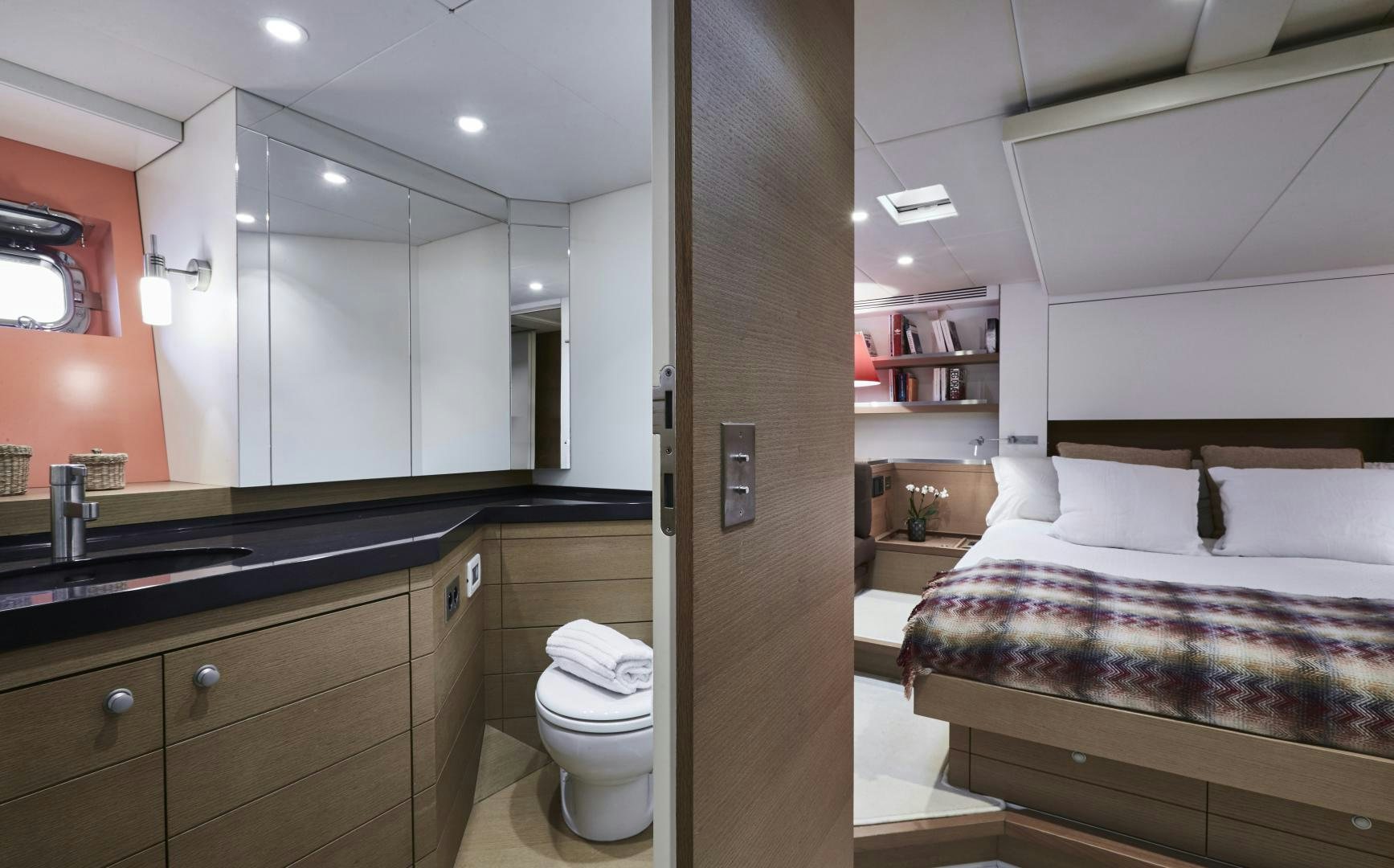 a bathroom with a bed and a sink aboard CAPRICHO II Yacht for Sale