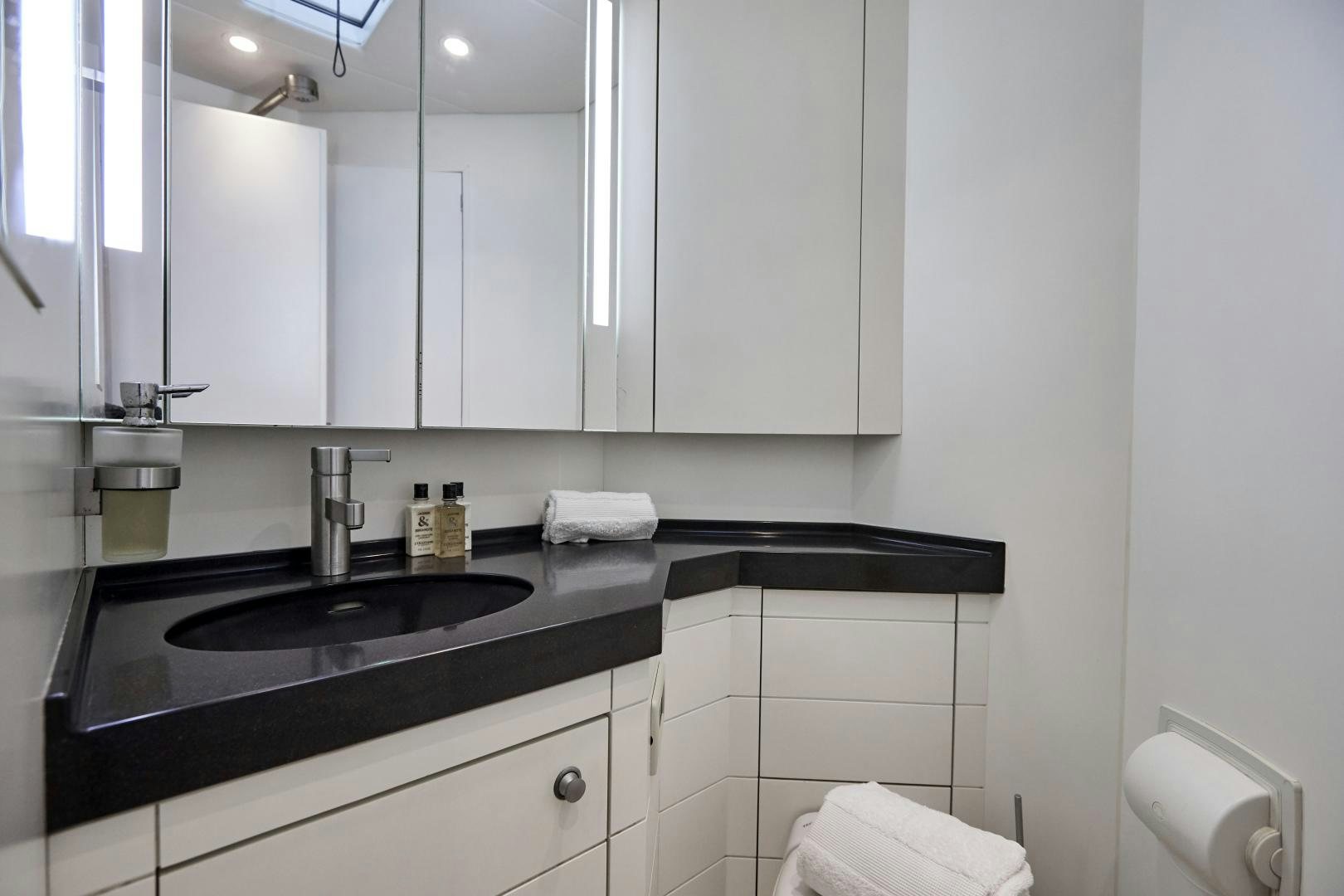 a bathroom with a sink and a mirror aboard CAPRICHO II Yacht for Sale