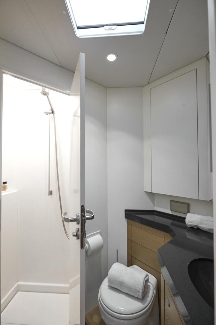 a bathroom with a toilet and a sink aboard CAPRICHO II Yacht for Sale