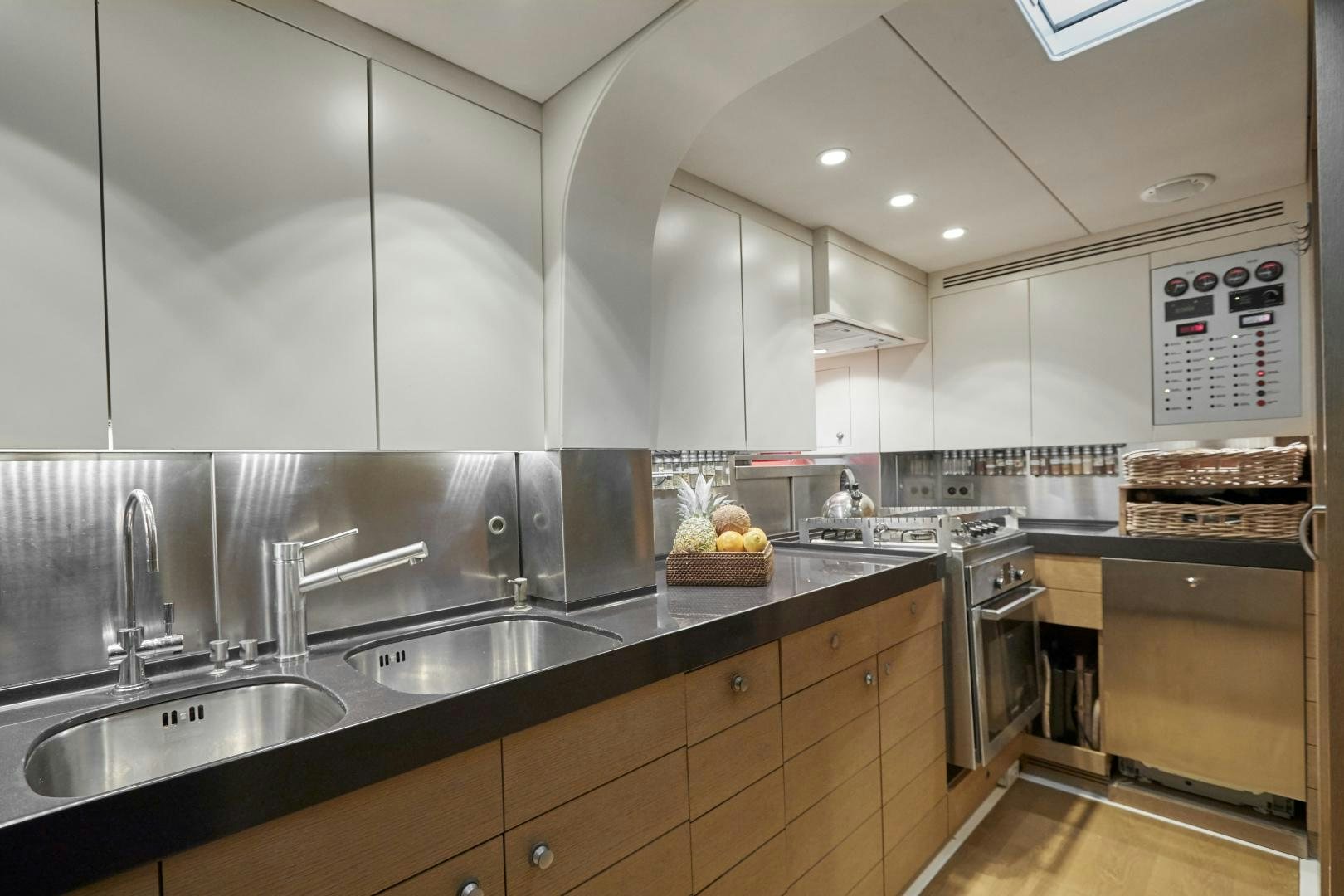 a kitchen with white cabinets aboard CAPRICHO II Yacht for Sale