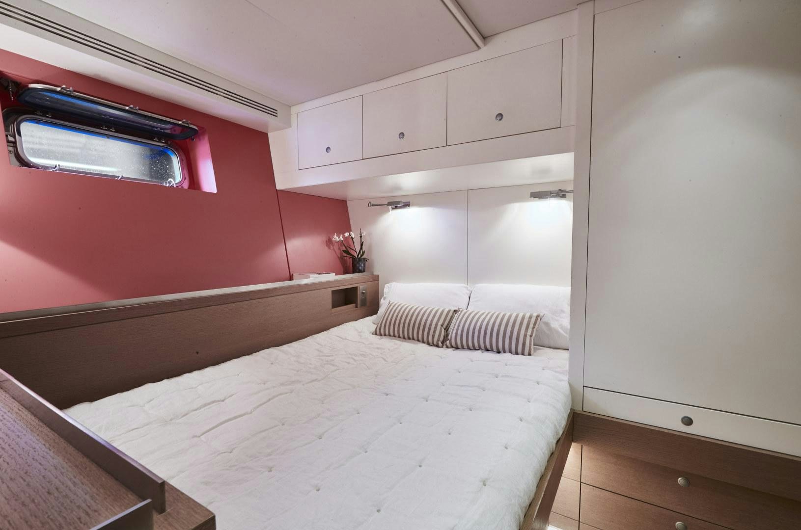 a room with a bed and a microwave aboard CAPRICHO II Yacht for Sale