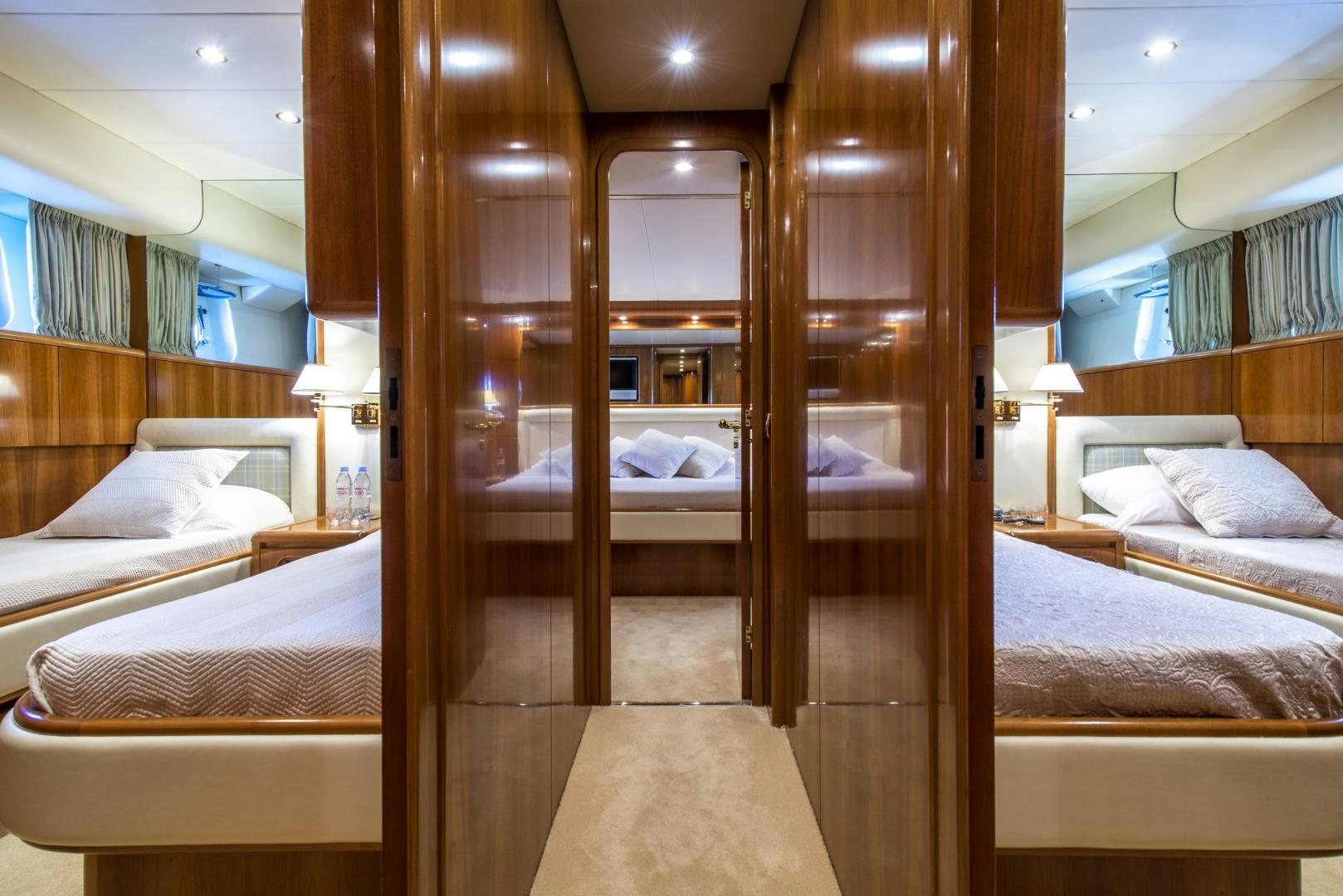 a room with a bed and a mirror aboard ACE1 Yacht for Sale
