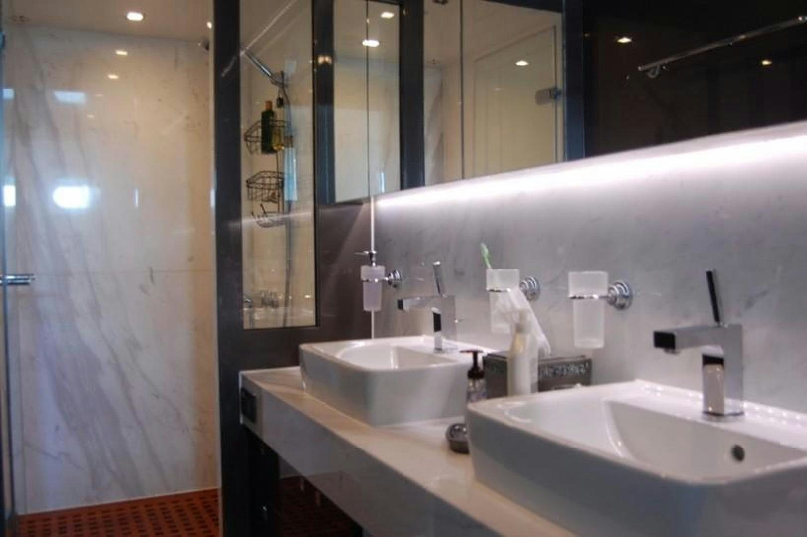 a bathroom with several sinks aboard LUCKY DOG Yacht for Sale