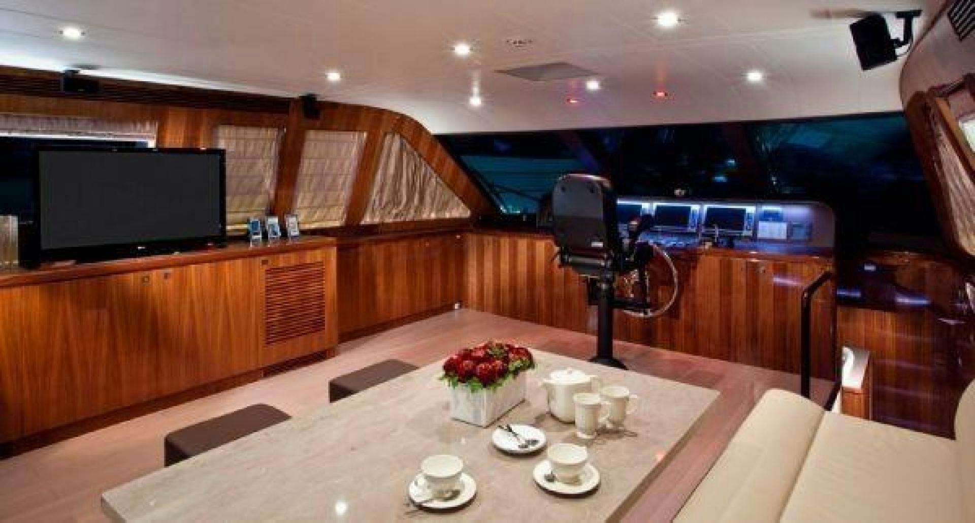 a room with a table and chairs aboard LUCKY DOG Yacht for Sale