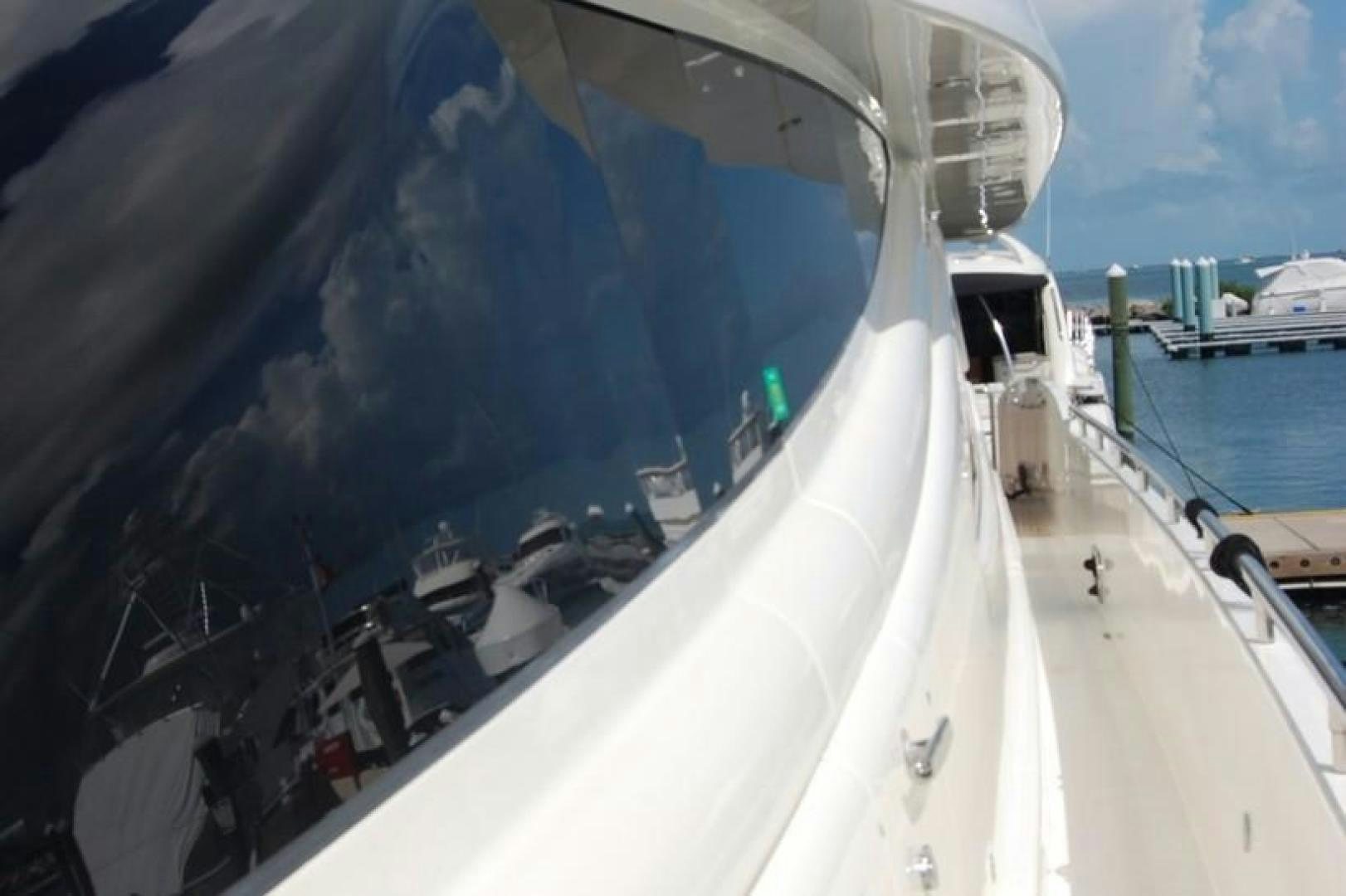 a large white boat with a large round window aboard LUCKY DOG Yacht for Sale