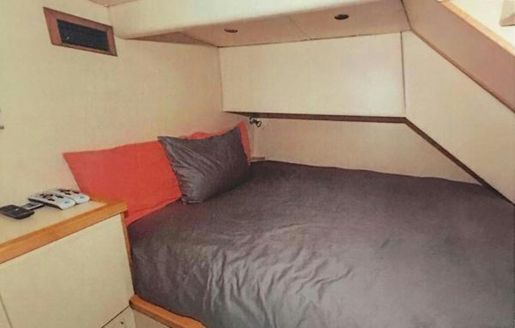 a bed with a phone on it aboard ARTHUR'S WAY Yacht for Sale