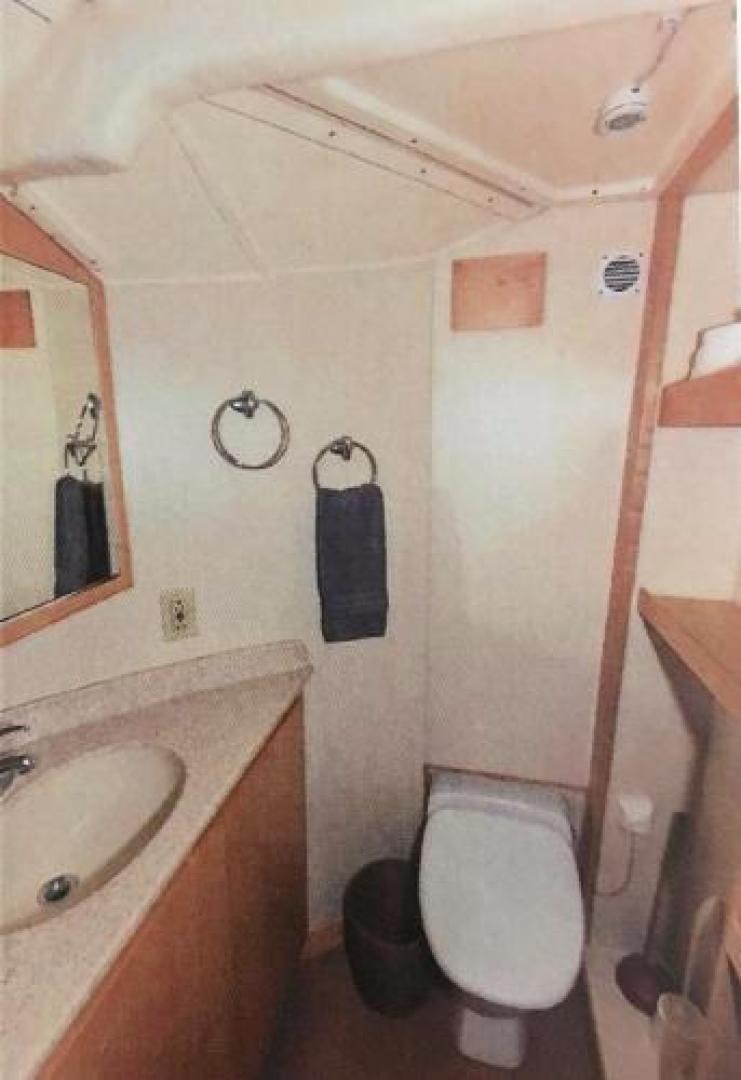 a bathroom with a toilet and sink aboard ARTHUR'S WAY Yacht for Sale